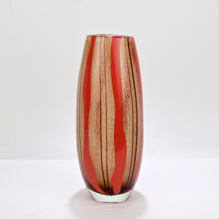 A good Murano glass vase with red and purple stripes.

In the style of Flavio Poli with a thick body, bullicine and 'a face' decoration.

Measure: Height ca. 12 1/2 in.

Items purchased from this dealer must delight you. Purchases may be