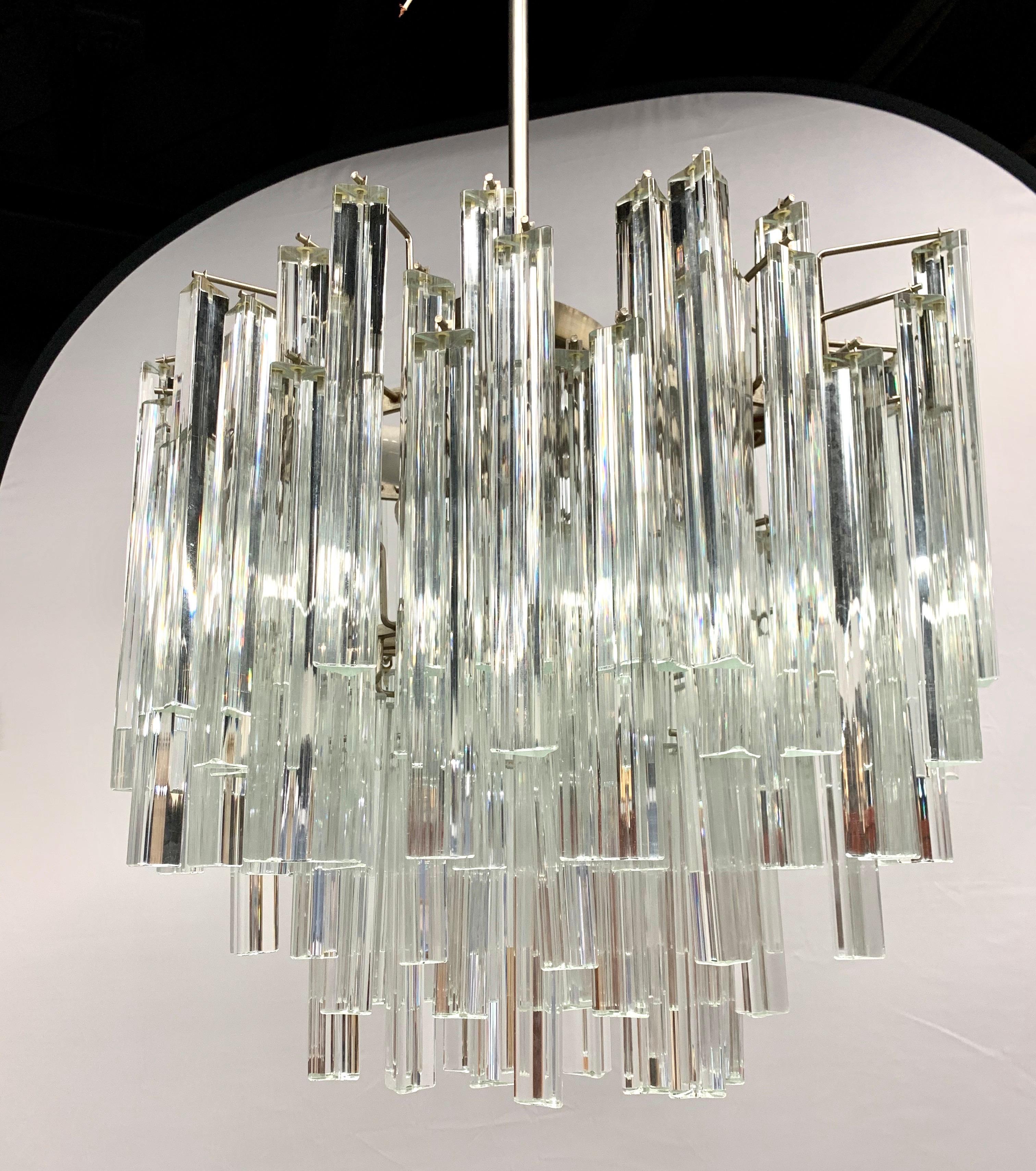 Stunning Camer Glass prism chandelier that features a metal rod and then a steel chain to the ceiling, see pics. Camer Glass chandeliers are true period pieces from the 1970s and have been featured in countless articles in Architectural Digest and