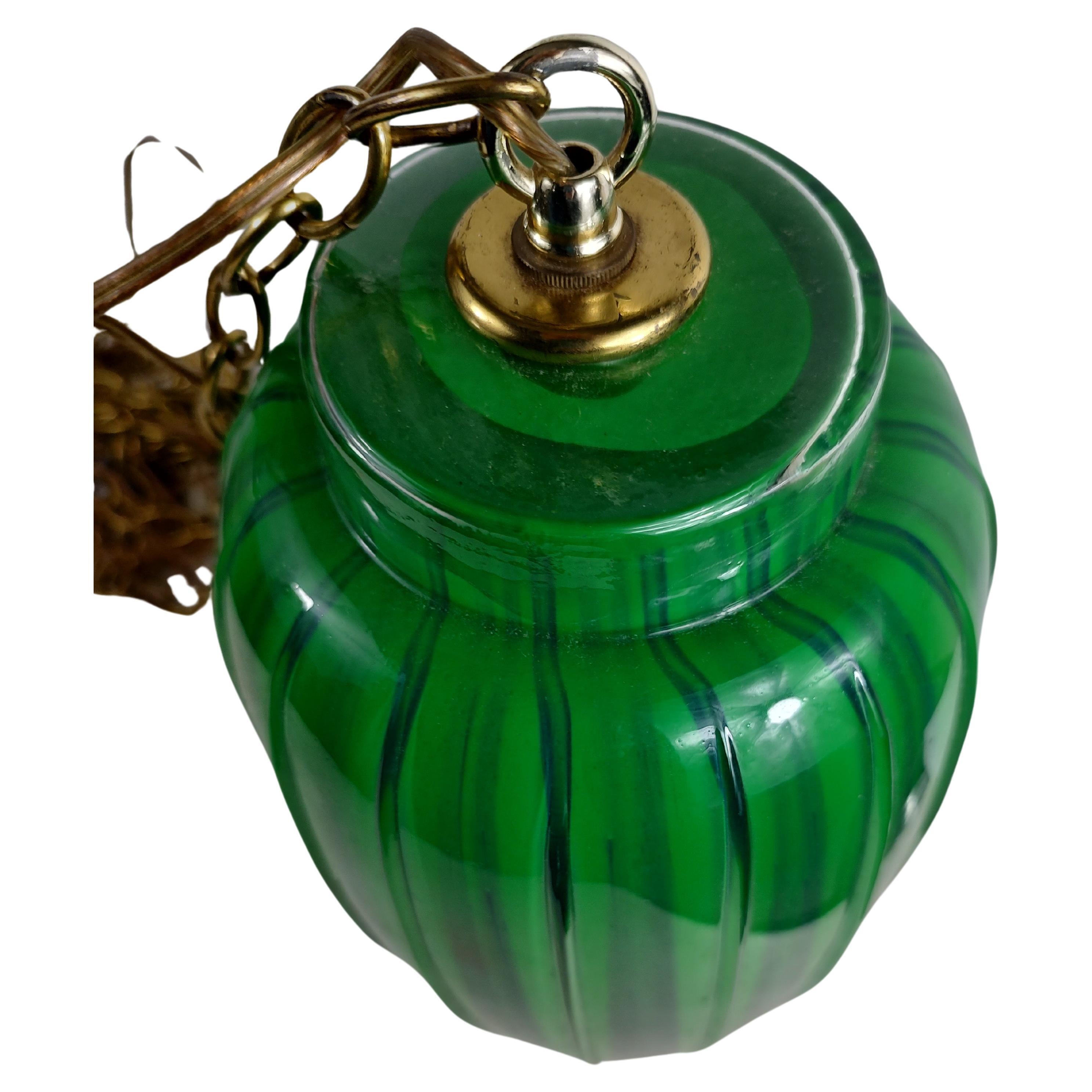 Fabulous colors dark emerald green to a bluish green. Ribbed glass body with lots of chain to be hung swag style in any room and add a little bit of color. In excellent vintage condition with minimal wear. Glass fixture is about 17.5 by 7.25