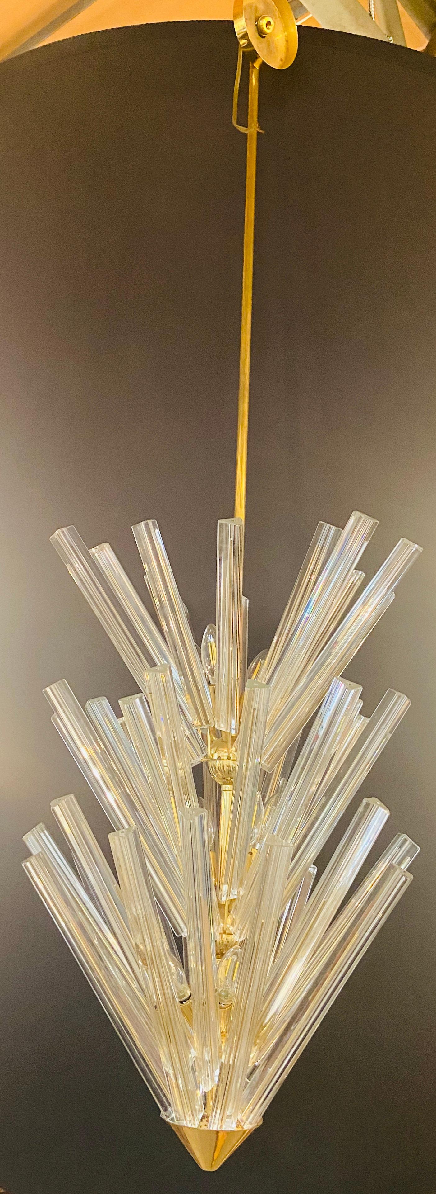 An impressive and stylish Mid-Century Modern large 5-tier starburst chandelier by the Italian Camer Glass design. Made in 1970s this lush chandelier features numerous Vinini Triedre Murano glass rods arranged into a conical shape. The chandelier is