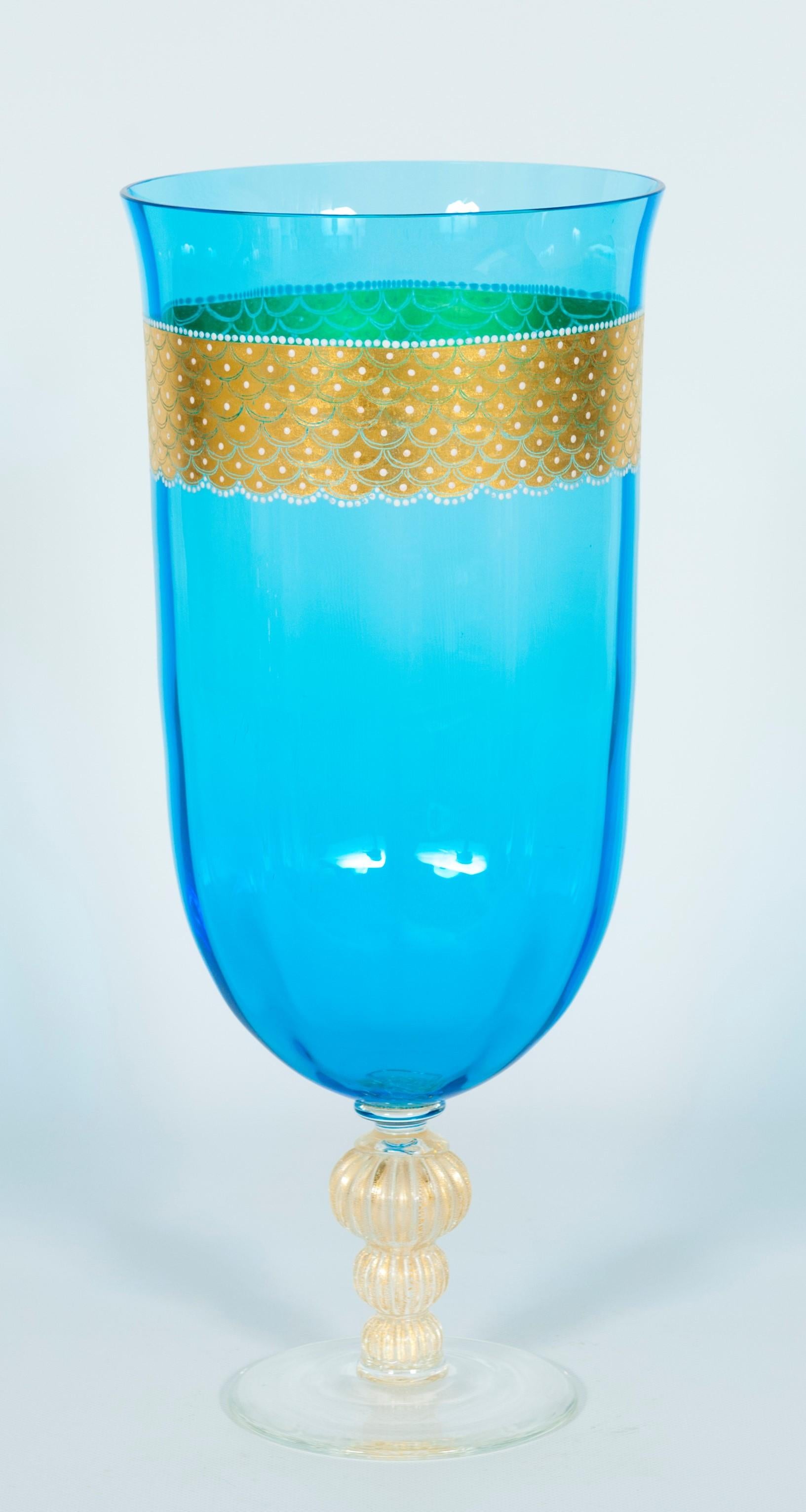 Mid-Century Modern stemware in blown Murano glass. Blue color with gold finishes, 1990s, Italy.
The exceptional dimensions and the Fine gold finishes make it a truly unique, one-of-a-kind piece of Venetian art.
A wavy glass stem with gold finishes