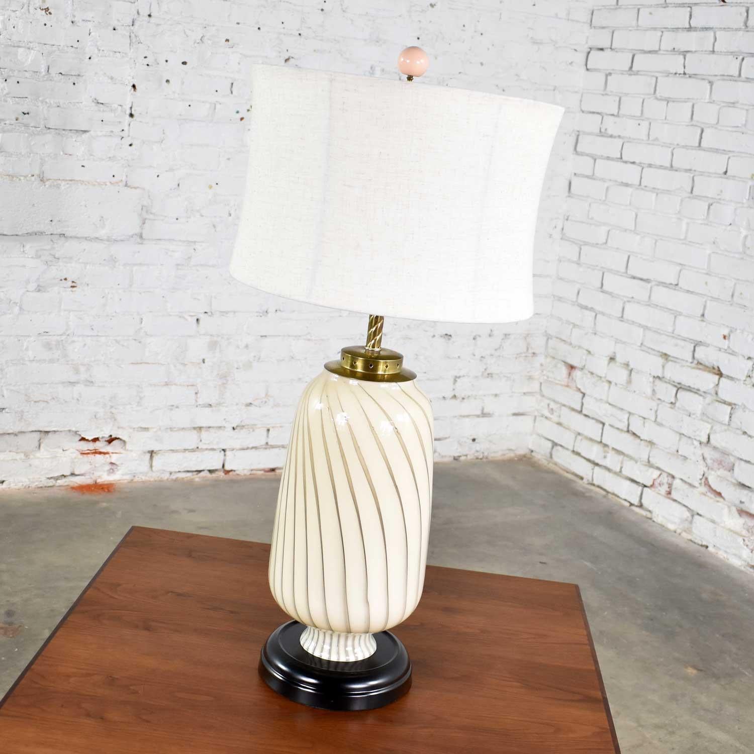 Beautiful Mid-Century Modern Murano style blown glass table lamp in cream and taupe with black and brass accents. It is in fabulous vintage condition wearing a new fabric shade and having a fresh coat of black paint on its base. Please see photos,