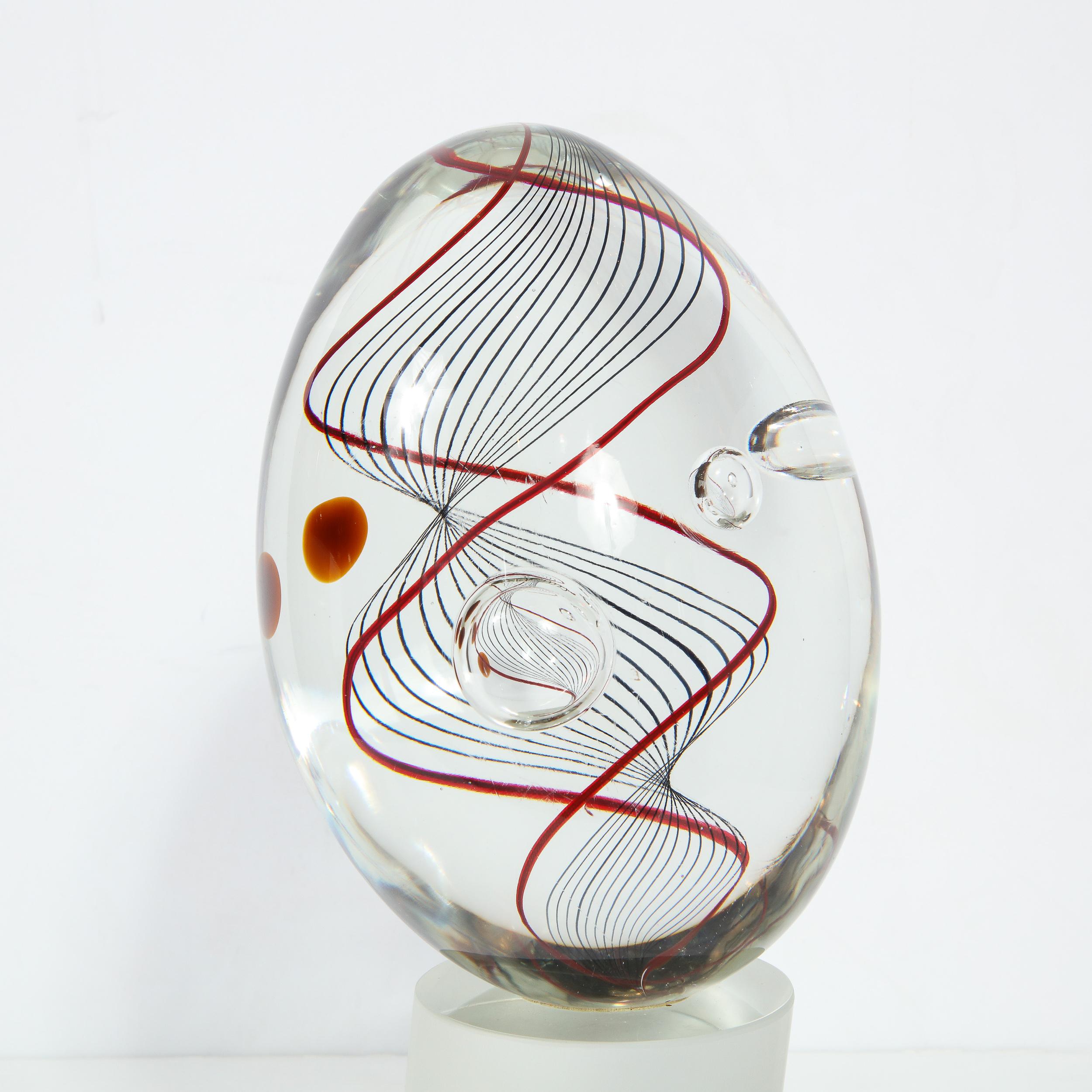 This stunning Mid-Century Modern glass sculpture was realized and signed by the illustrious atelier of Seguso, circa 1970. It features a volumetric cylindrical base leaning at a slight bias in frosted glass. An ovoid form with a spiraling helix-