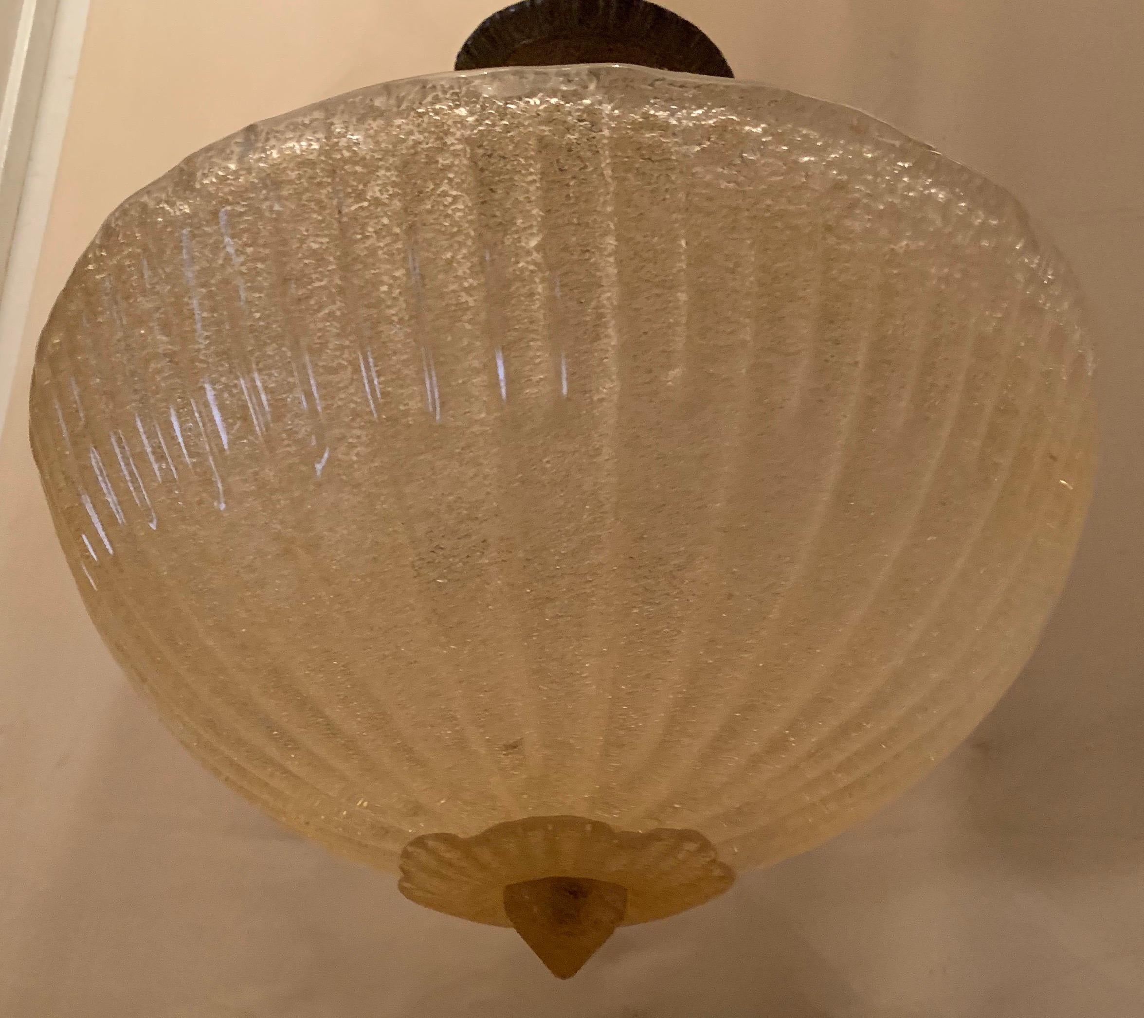 A wonderful Mid-Century Modern Murano, Venetian round art glass and brass housing semi flush pendant fixture with 3 new candelabra sockets and wiring.
In the manner of Barovier Seguso.
Height is adjustable by adding and removing chain.