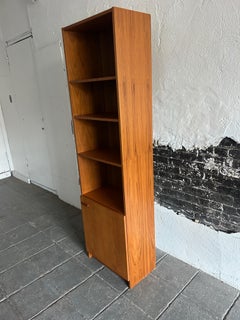 Mid-Century Modern narrow teak tall bookcase with cabinet door Made in Denmark