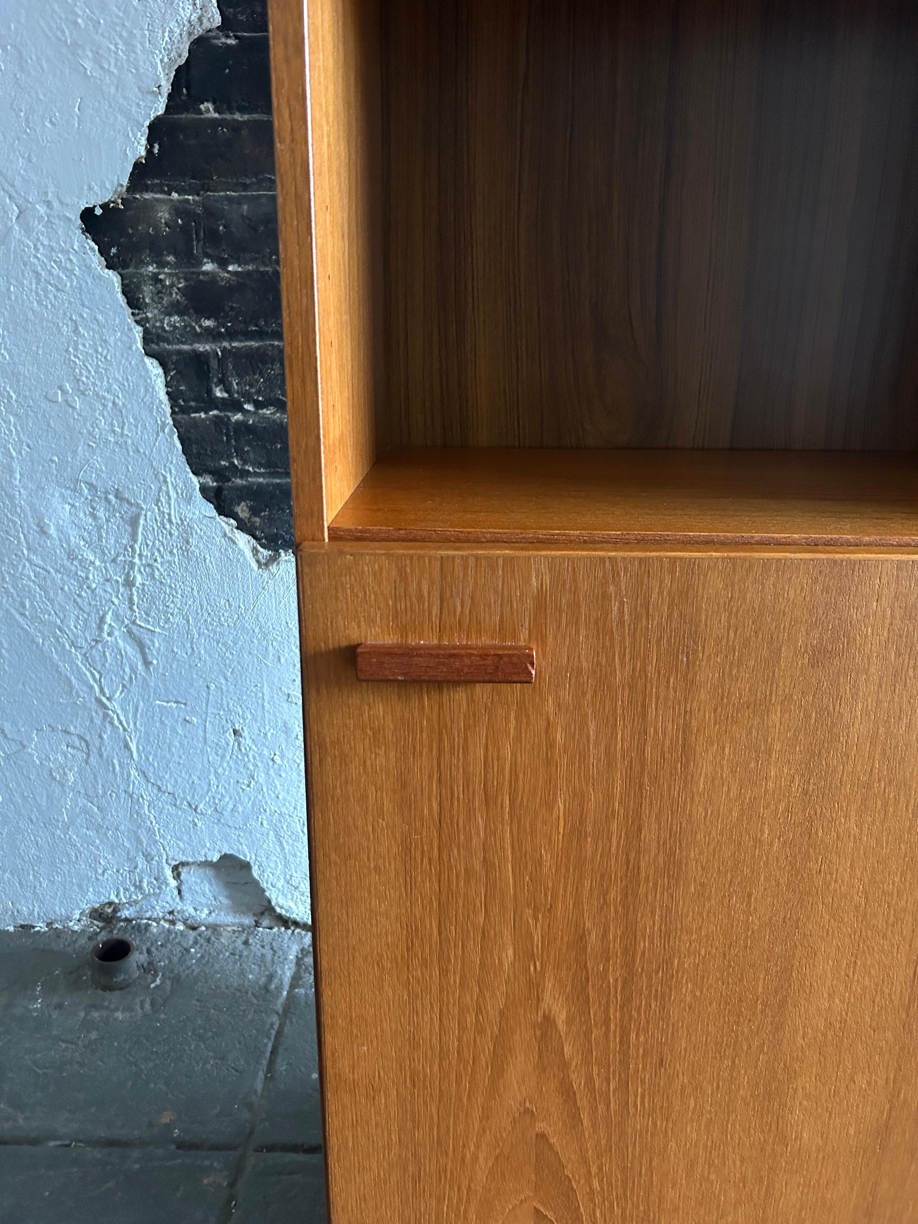 Danish Mid-Century Modern narrow teak tall bookcase with cabinet door Made in Denmark  For Sale