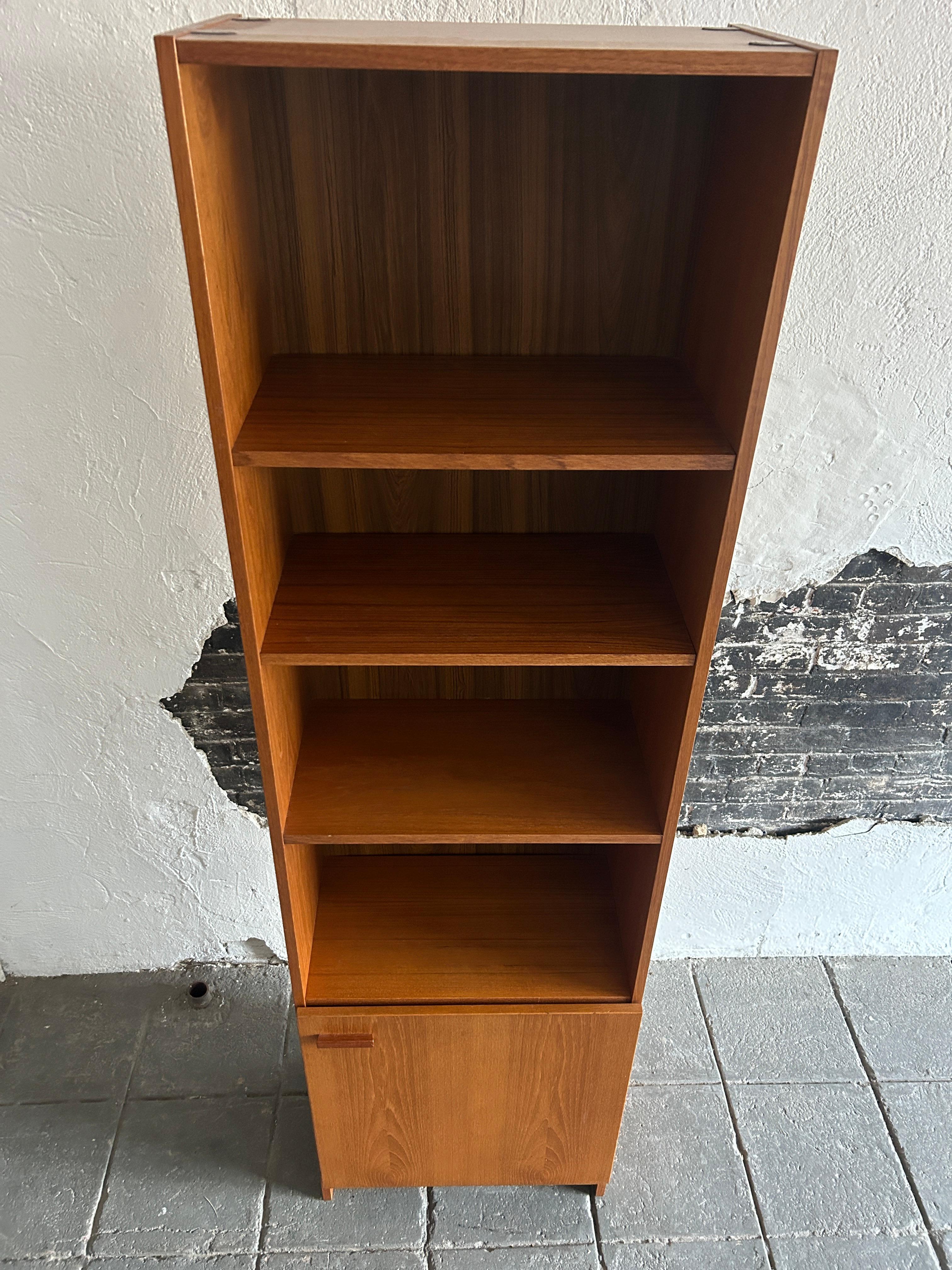 Woodwork Mid-Century Modern narrow teak tall bookcase with cabinet door Made in Denmark  For Sale