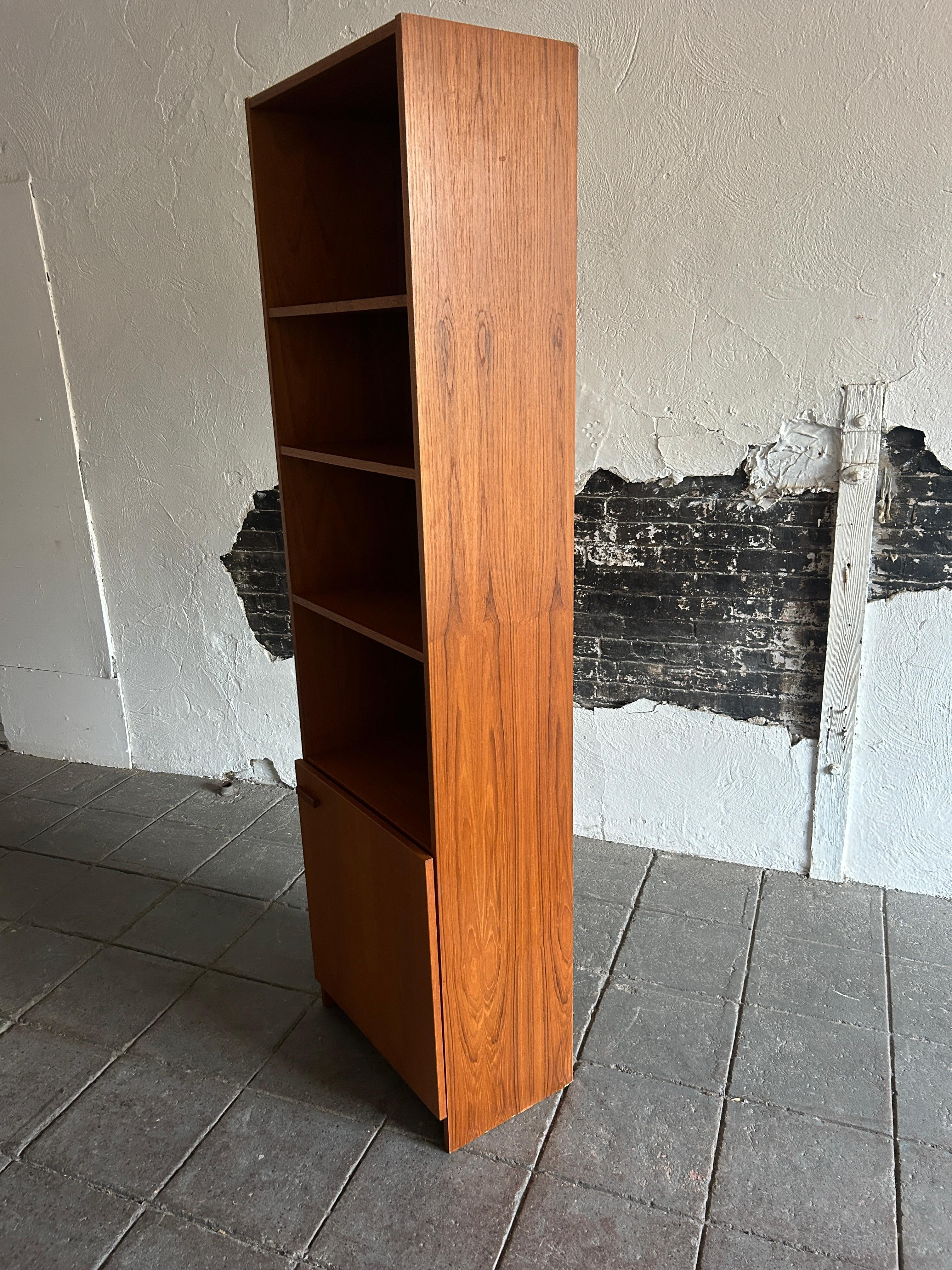 Mid-20th Century Mid-Century Modern narrow teak tall bookcase with cabinet door Made in Denmark  For Sale