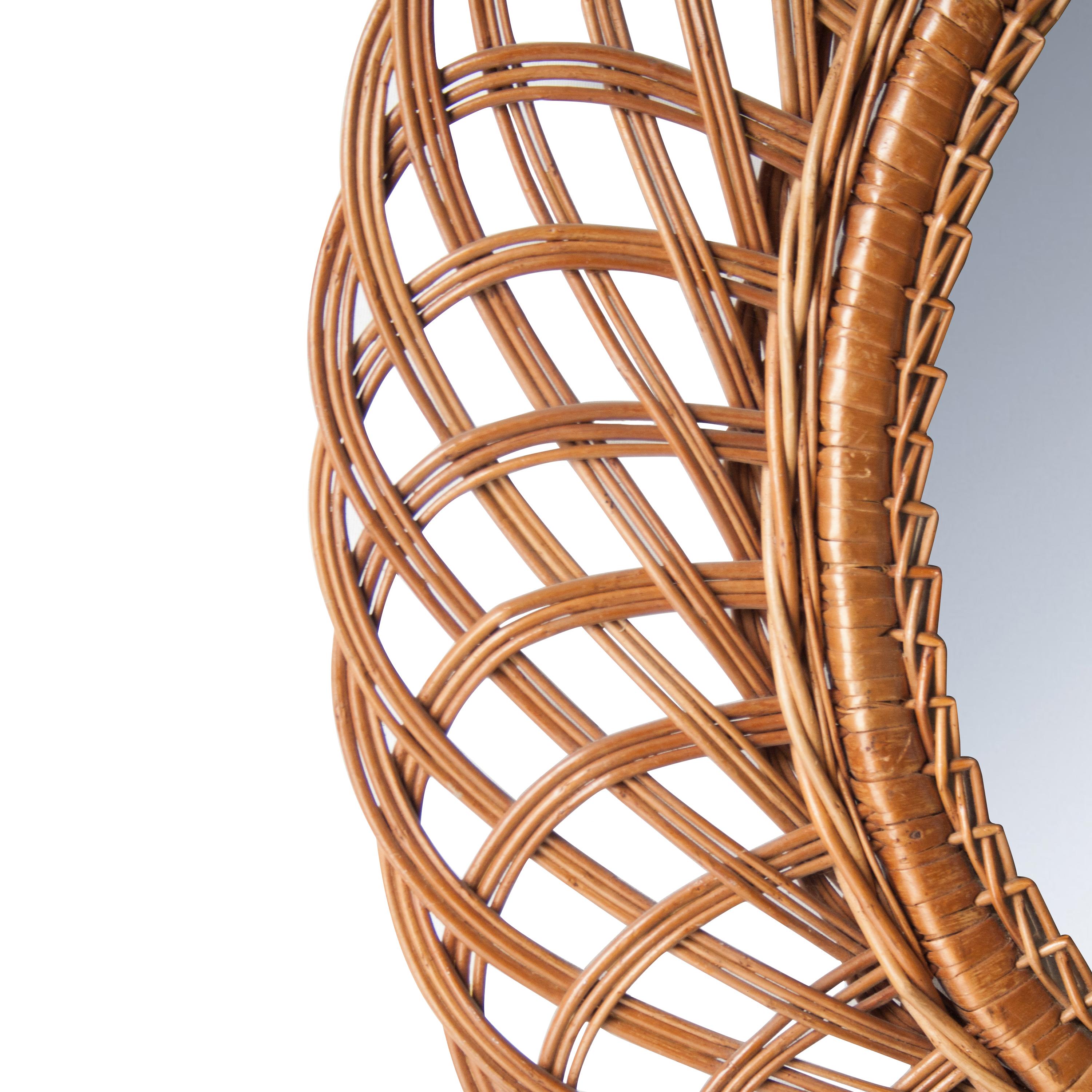 Oval shaped wall mirror made of natural fiber in France.