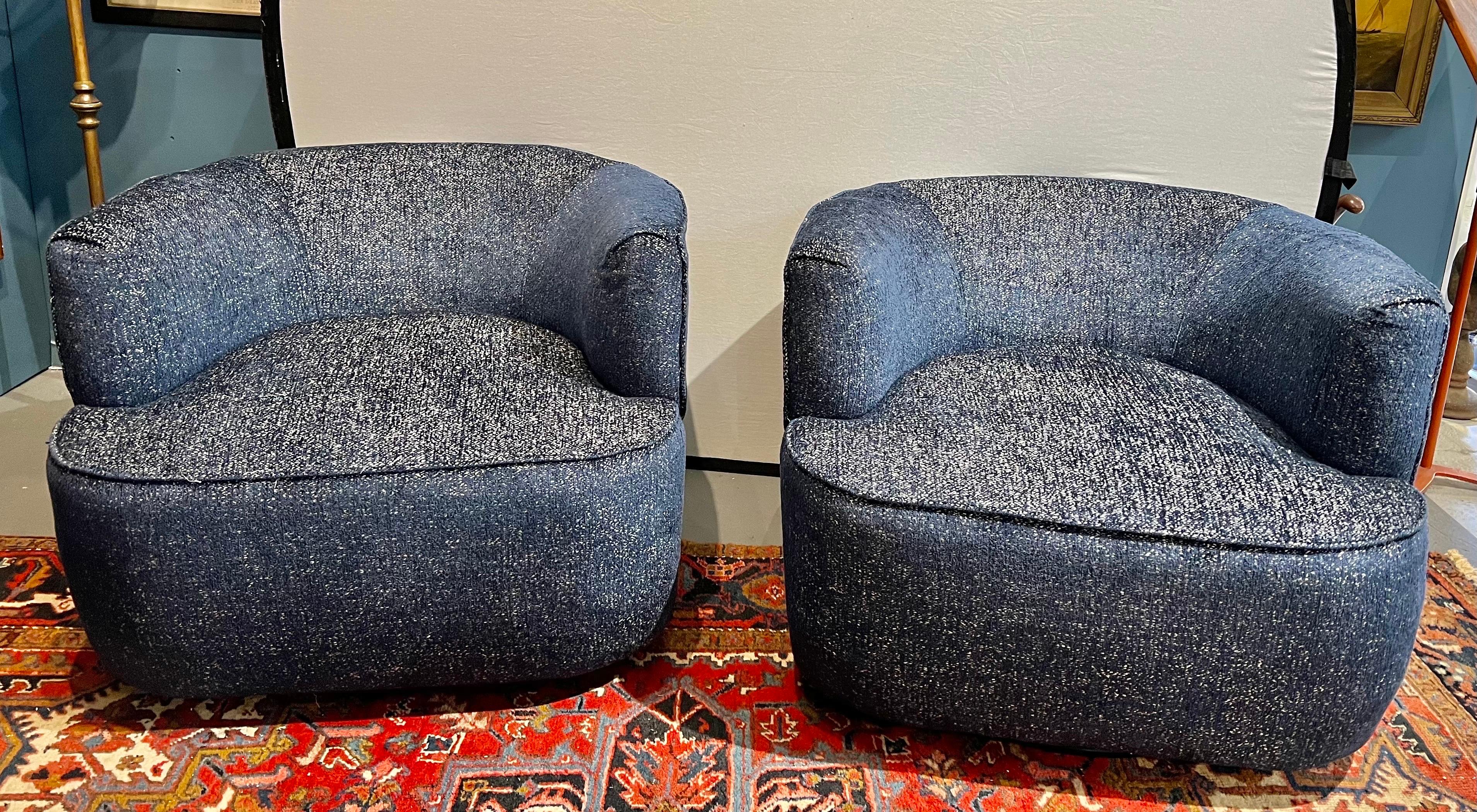 Elegant pair of mid century modern swivel chairs that have been updated in a luxurious fabric.  The chairs are sleek, elegant and sit beautifully.  All dimensions are below.  The upholstery is brand new.