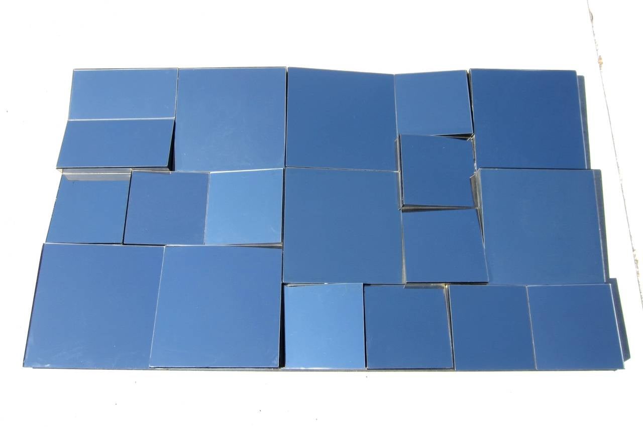 Incredible large sculpture mirror by Neal Small, circa 1970s.
It is multifaceted silver mirror with black wooden border and trim.
Shows many optical angels of a room. Photos taken on ground facing up to blue sky.
From an old Las Vegas estate.
