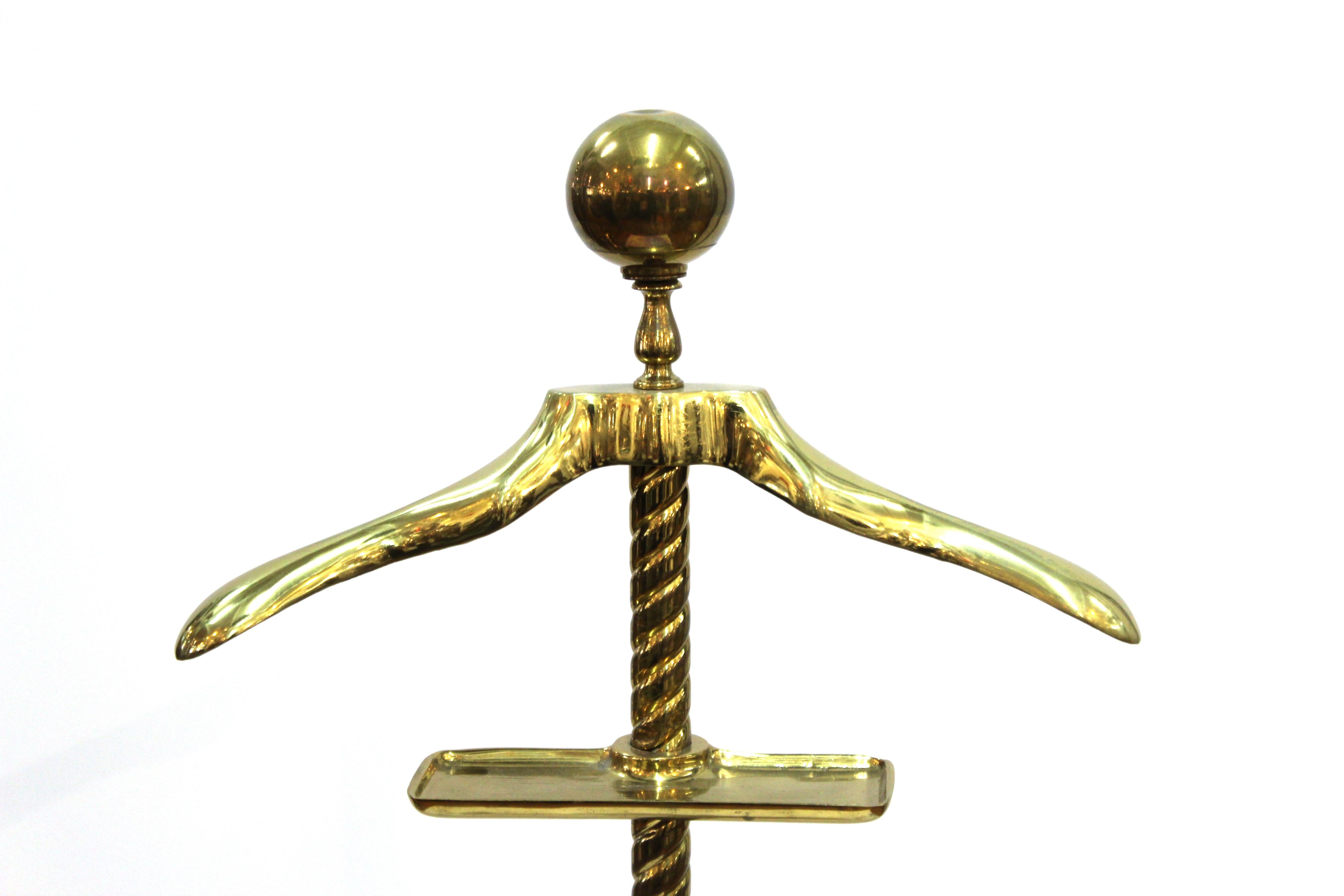 Mid-Century Modern neoclassical influence brass valet with twisted column and large ball finial. In great vintage condition with age-appropriate wear and use and a minor dent on the top of the brass ball.