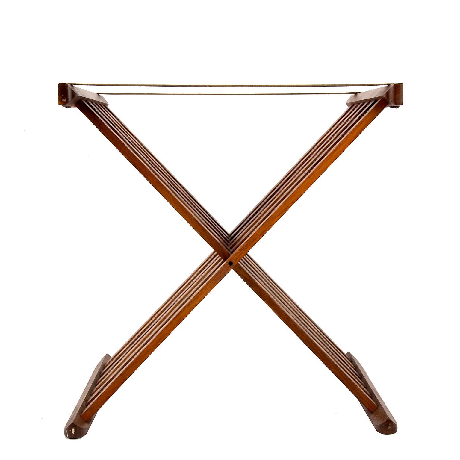 This classic x form folding teak wood stand is perfect for a large tray or as a chic luggage holder.
Change the straps to leather or some colorful fabric to add your own design to this timeless piece.