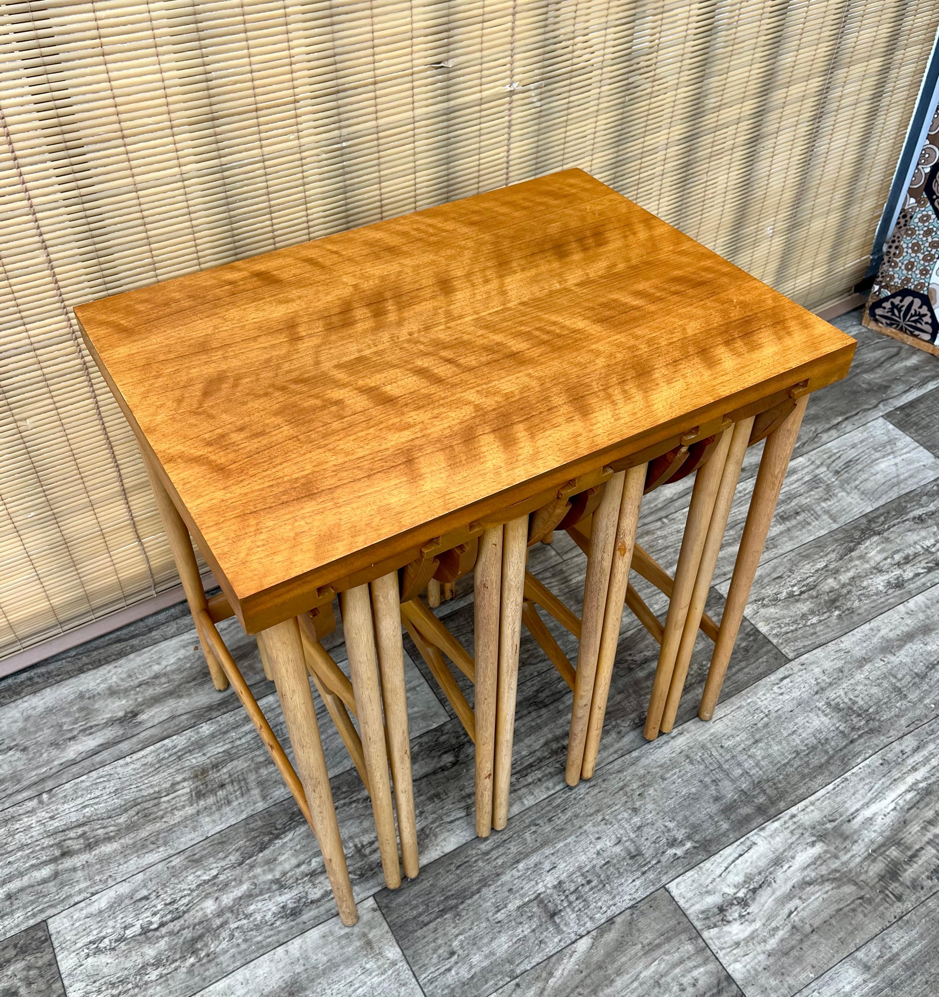 Vintage Mid Century Modern Nesting Tables by Bertha Schaefer for Singer and Sons. Circa 1950s
Feature a set of 4 round folding tables that slide underneath a rectangular side table with a quintessential sleek Mid Century Modern Design. 
I good