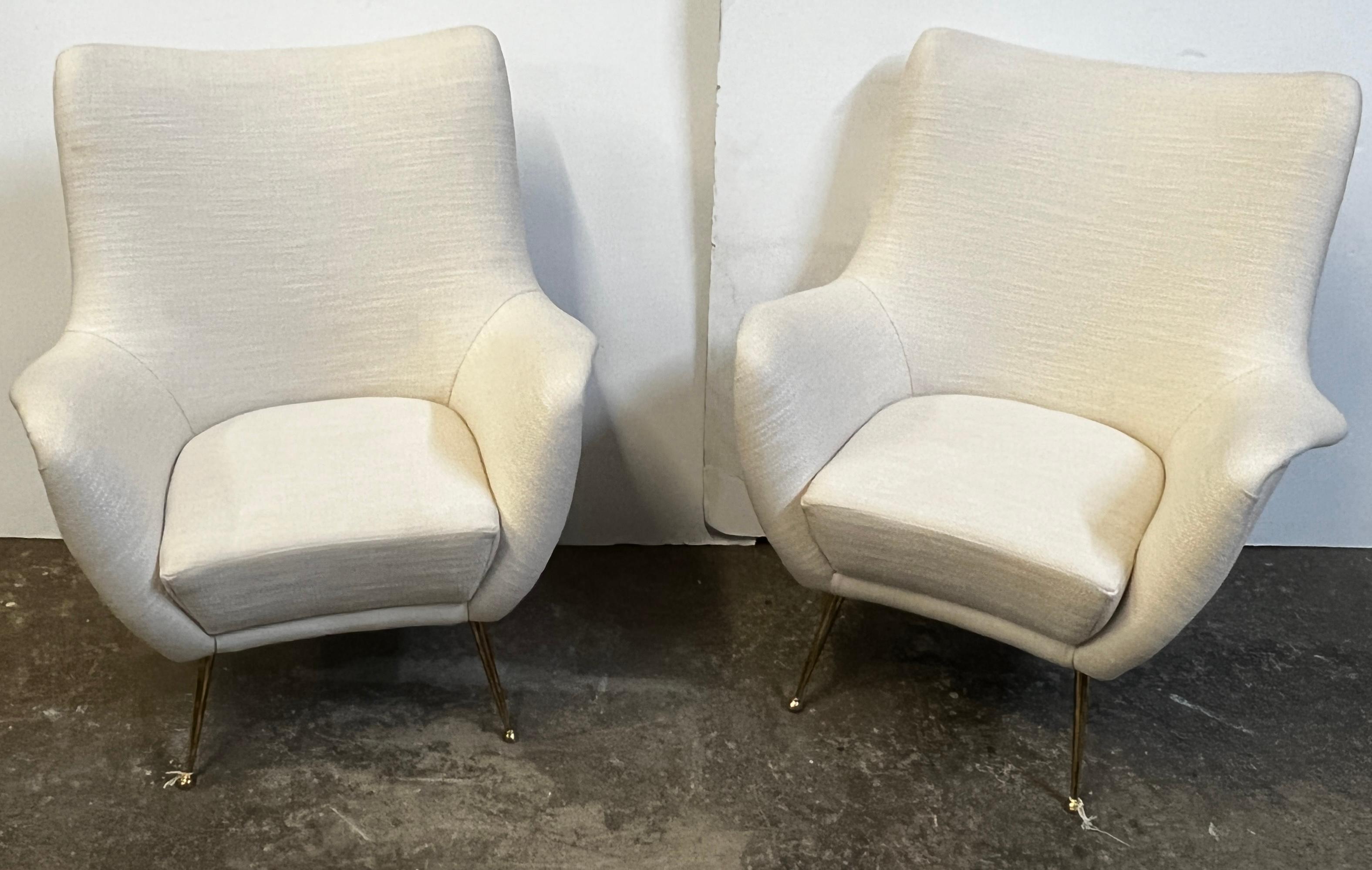 Beautiful pair of newly constructed Italian chairs attributed to a Mid Century Modern style. This lovely pair of chairs are featuring new stunning upholstery with 4 slender legs. The neutral color palette allows for an easy transition for this pair