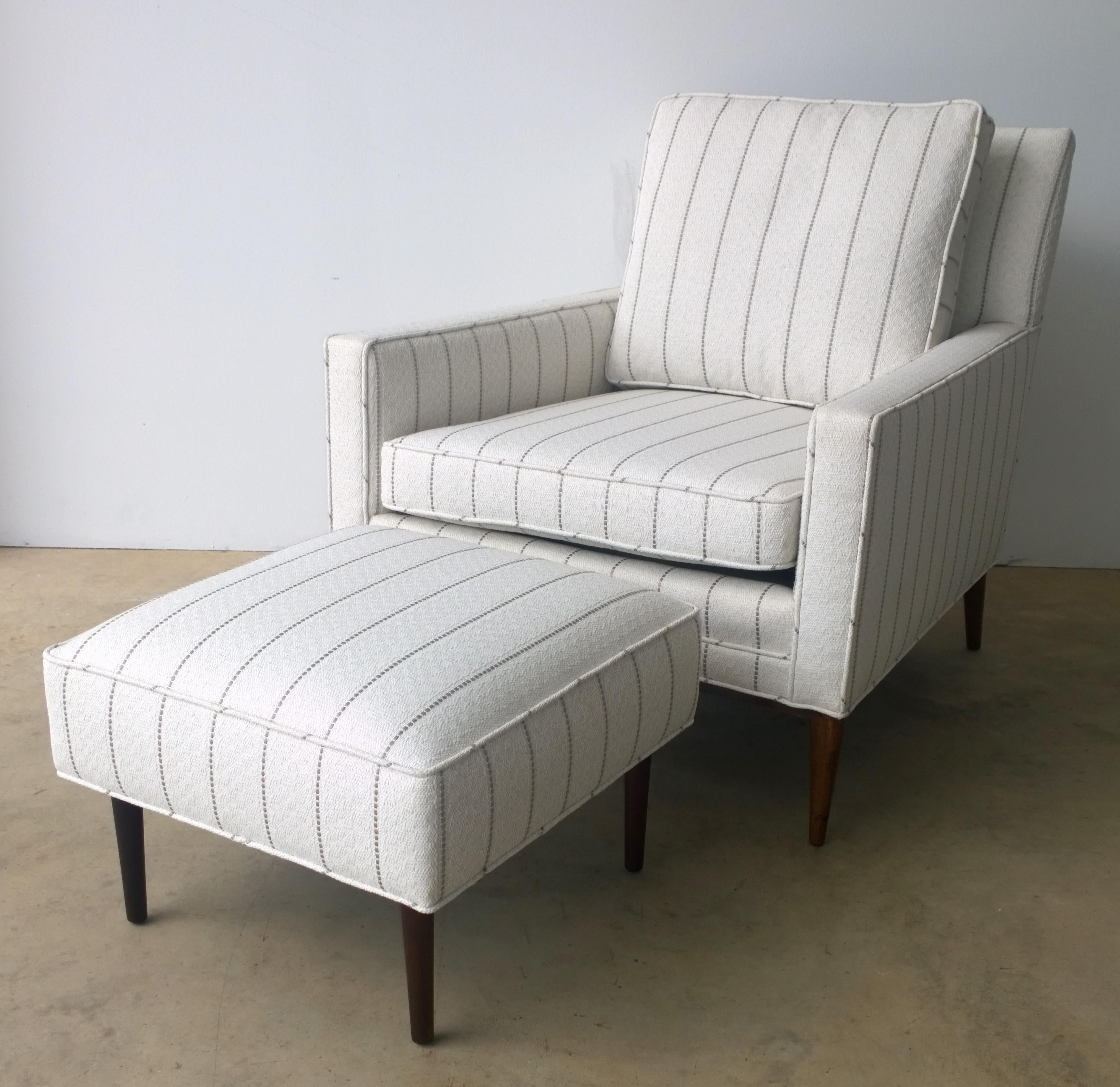 Offered is a Mid-Century Modern newly upholstered in white with a gray pin stripe Paul McCobb arm or lounge chair with Paul McCobb stool that was not originally sold with this chair. The chair is for sale and the stool is an extra newly upholstered