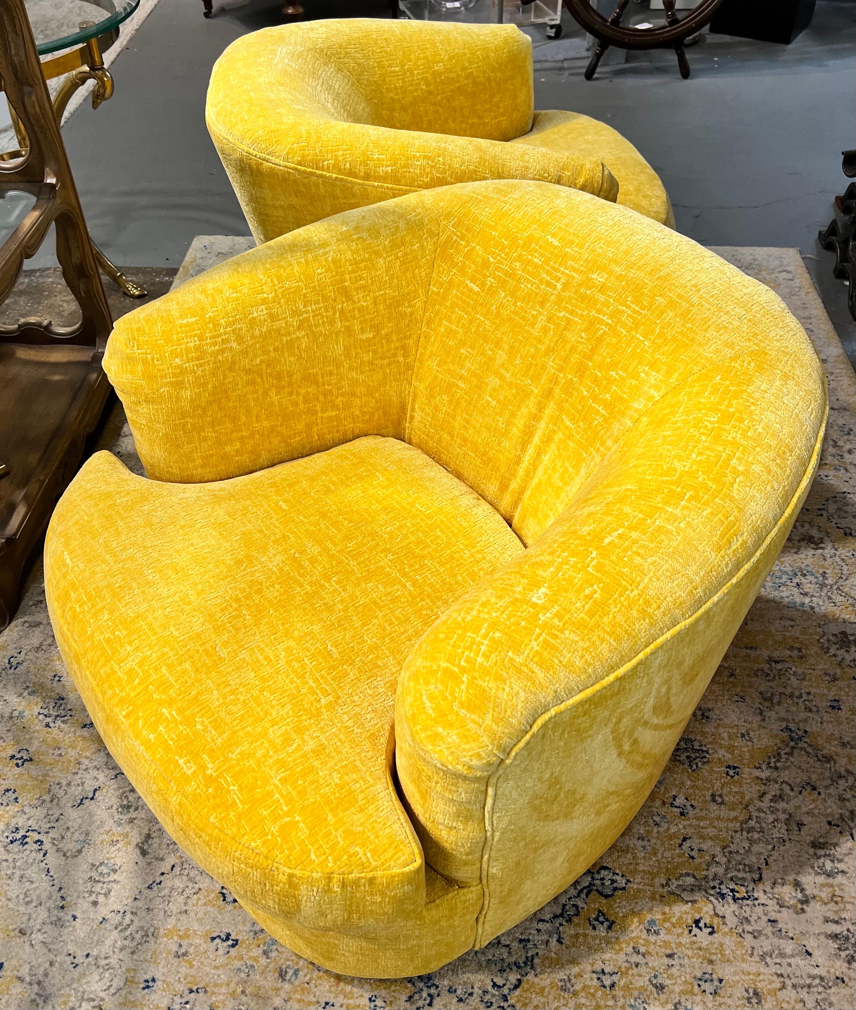 Sleek and sexy newly upholstered true Mid-Century Modern swivel club chairs that match. The new Donghia fabric is to die for with a rich yellow color scheme with slight gold tones. Extremely comfortable and 360 degree swivel, of course. Mint