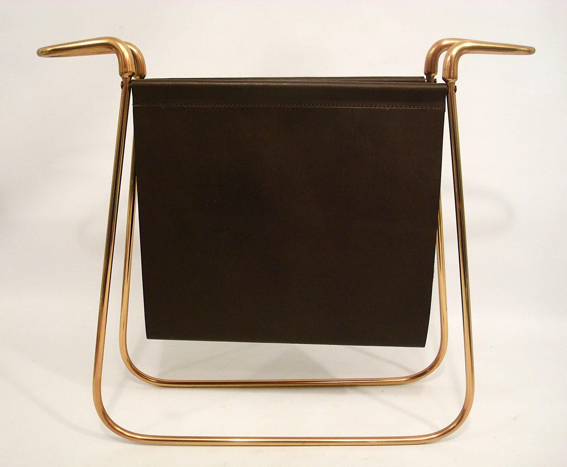 Newspaper rack Carl Auböck  ca. 1938
Design / Mid-Century magazine rack model 3608, Carl Auböck II, ca. 1938, brass, leather.
Made from 1930 to 1950.
Technique: brass, cast, leather

Description
In the 1920s, Carl Auböck began developing his first