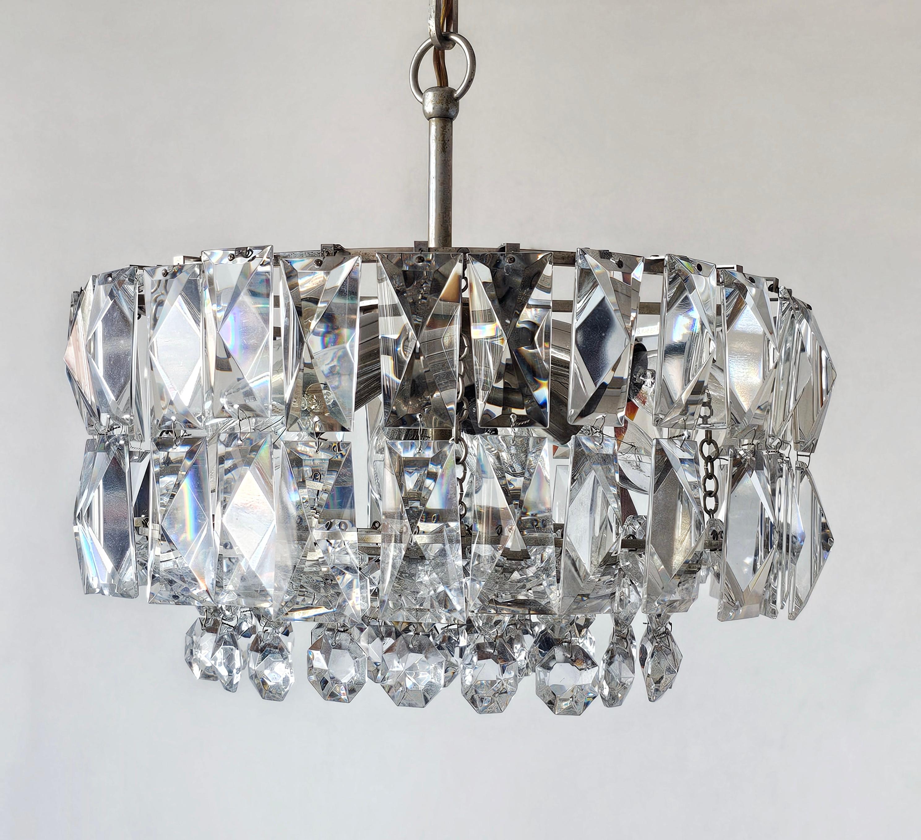 In this listing you will find an elegant Mid Century Modern crystal chandelier with nickel plated fixture manufactured by Bakalowits and Sohne. It features amazing 8 lights, providing enough light for practical uses, as well as craftsmanship with