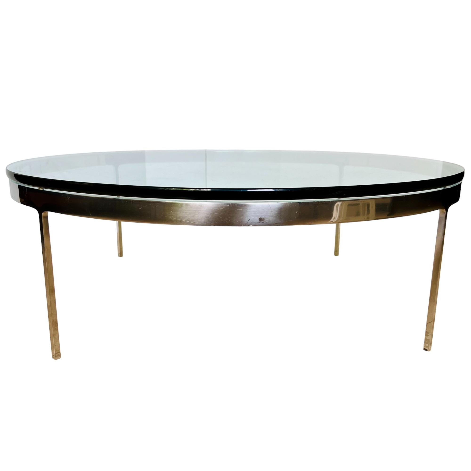 A vintage mid-century modern low round table attributed to Nicos Zographos of the TA35 line circa 1960. Seamless design stainless steel frame with stiletto legs and a 3/4