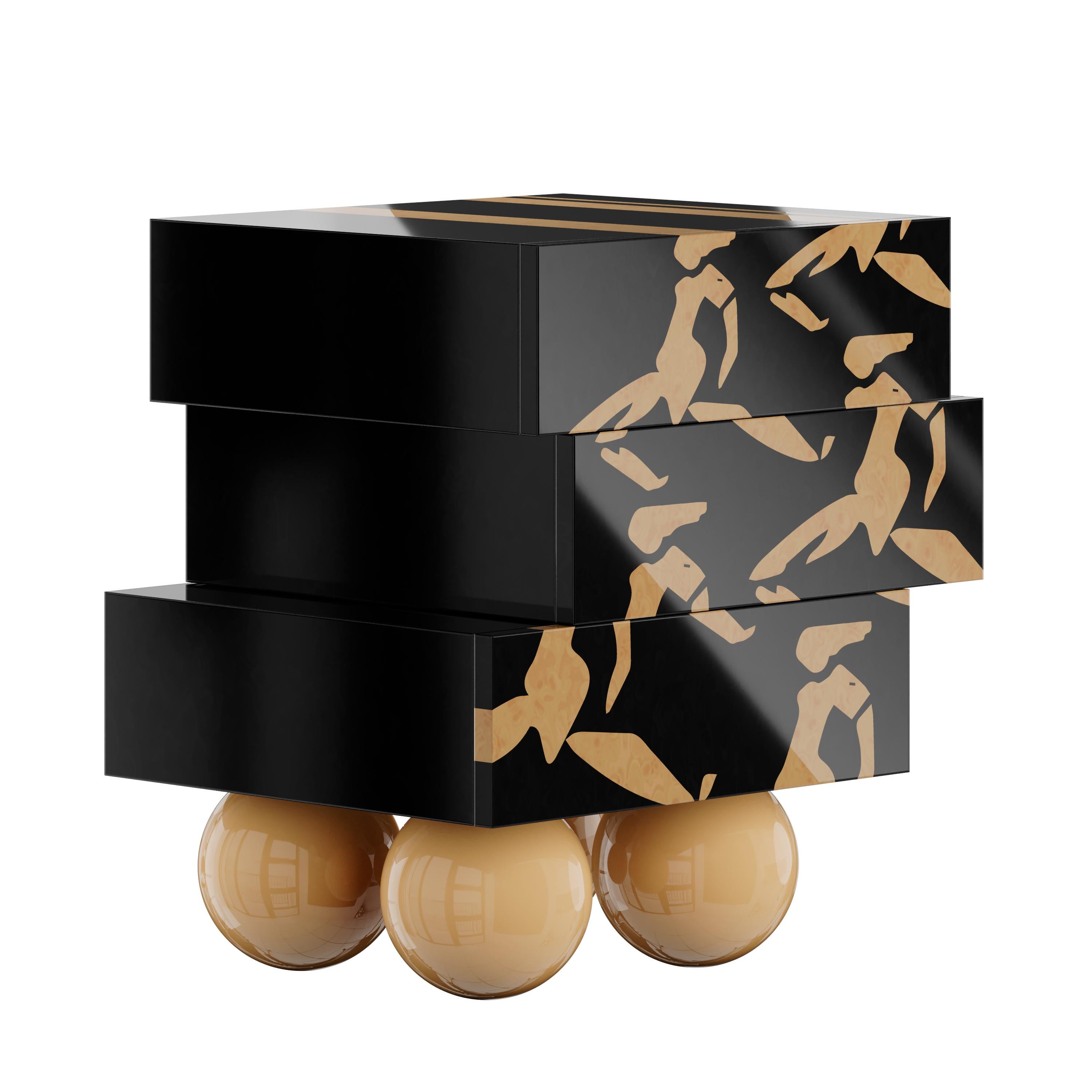Nice Bedside table is the quintessence of modern design. Its dynamic silhouette features three drawers resting on four legs of wooden spheres. The exceptional geometric design of this modern nightstand allows it to become a must-have piece for your