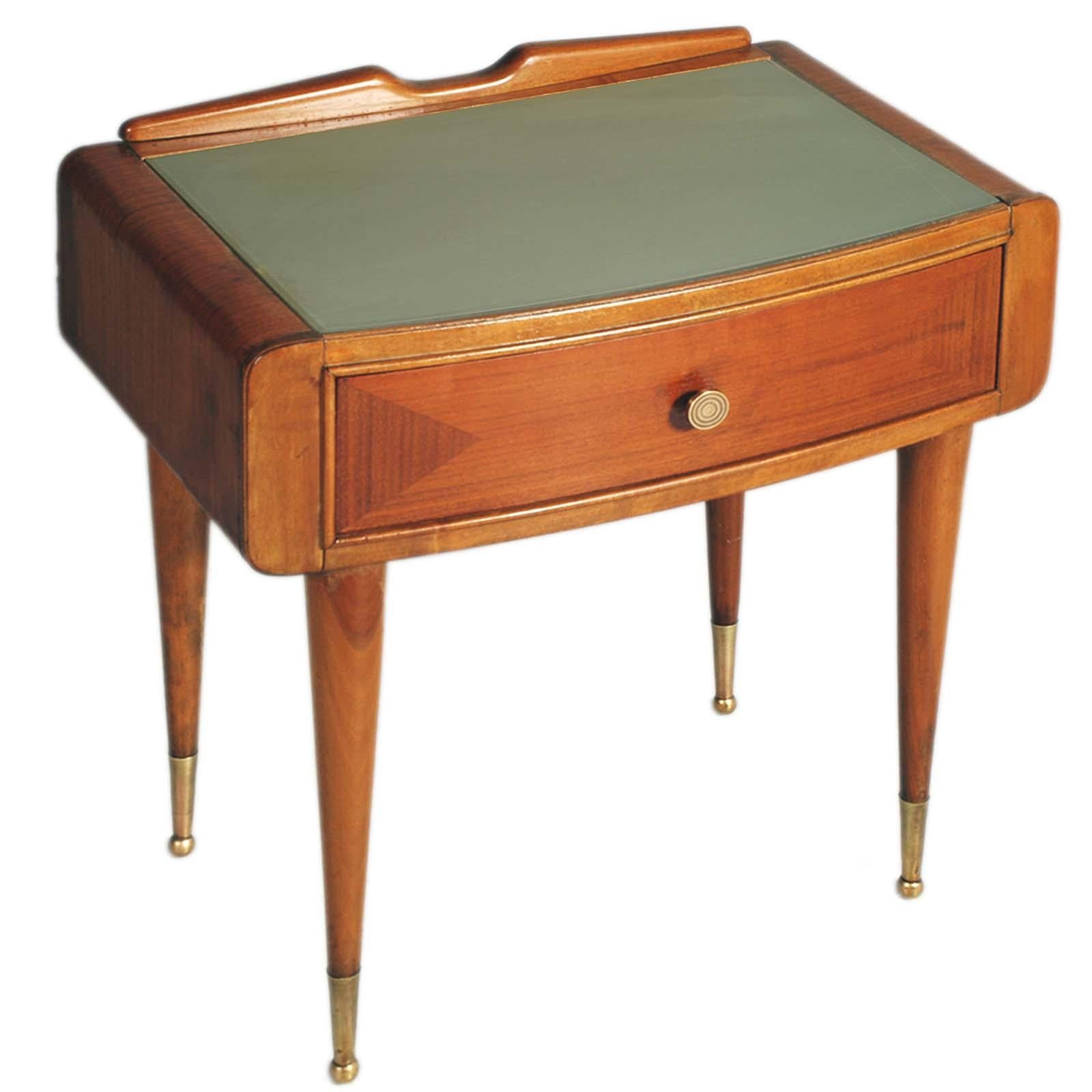 1950s bedside table attributed to Paolo Buffa for Mobile di Cantù, in solid walnut and veneered walnut front drawer, painted glass top, gilded brass accessories.

ABOUT PAOLO BUFFA
One of the greatest Mid Century Modern designers in Italy and  in
