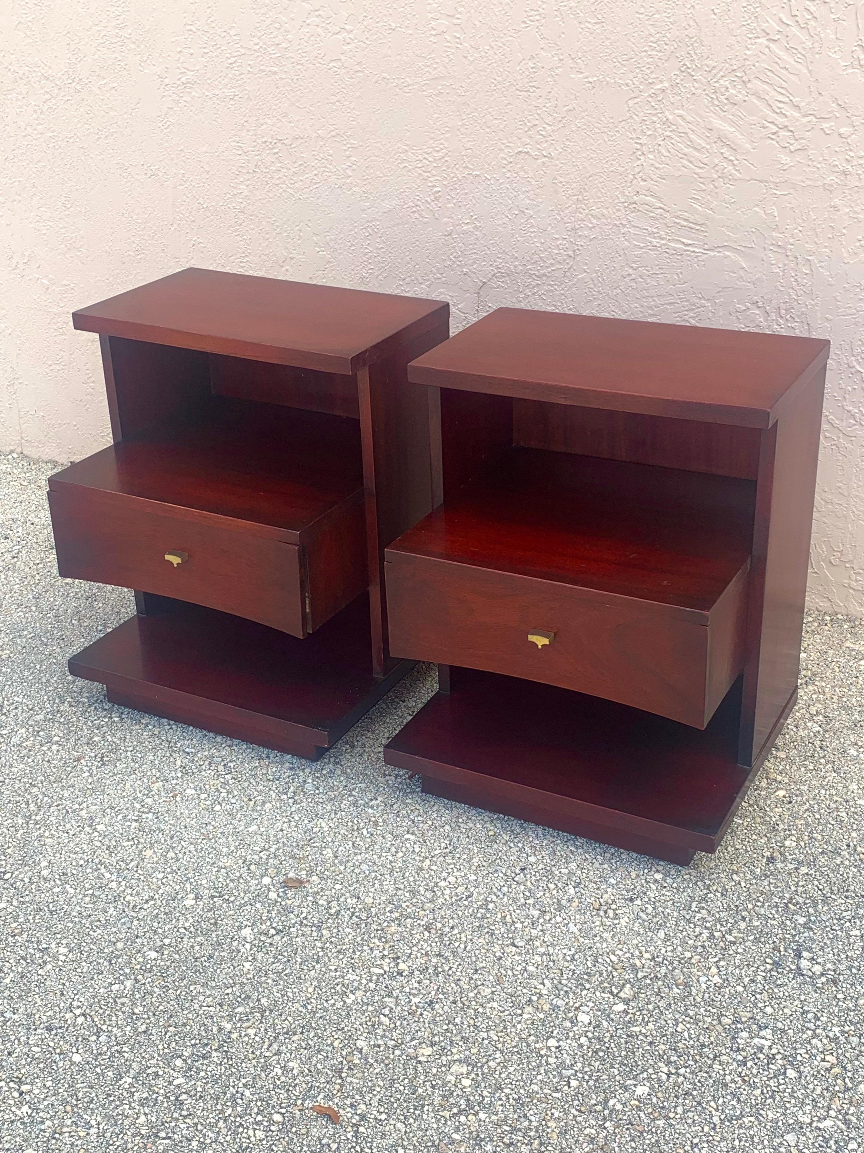 Pair of nightstands by Kent Coffey for their Sovereign line. In Mahogany. Finish is a deep wine red color. The finish is original but has been deep cleaned and polished. 

Nightstands are 3 tiered and boast a very solid construction. Middle drawer