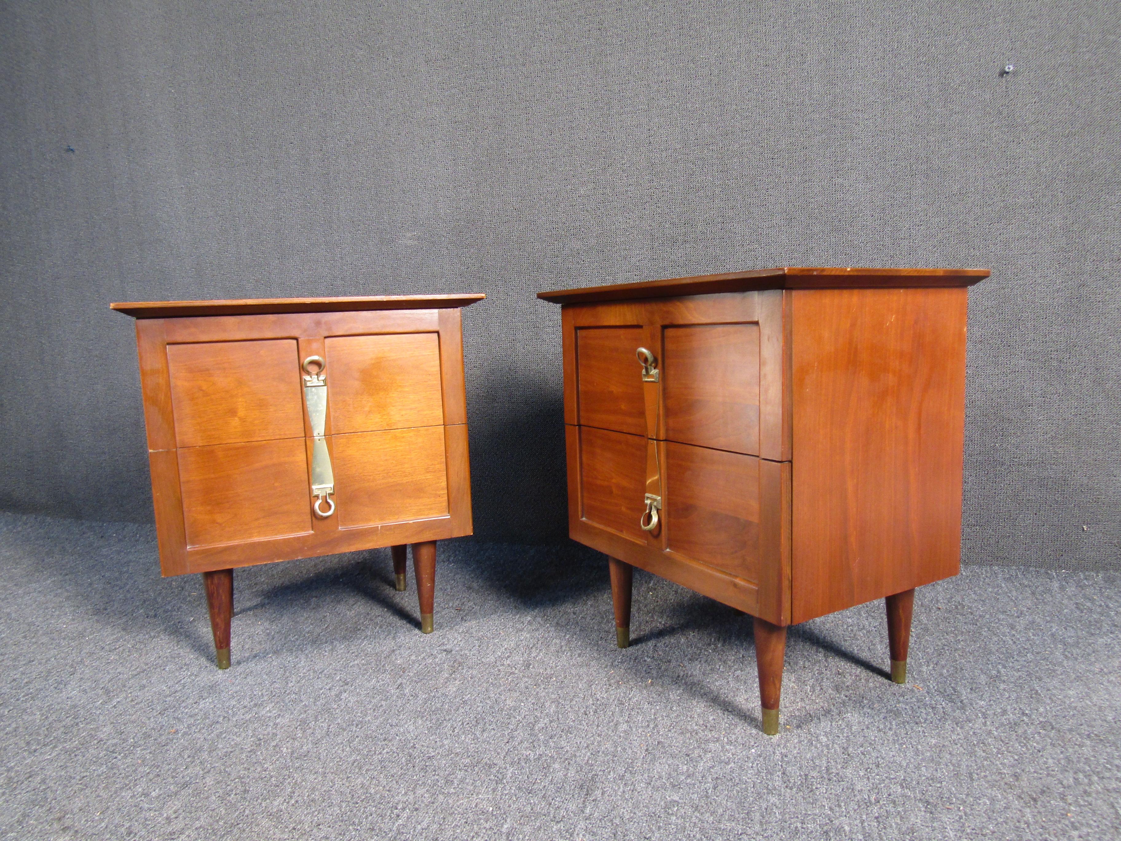 Unique pair of mid-century modern nightstands. Each with interesting brass handles for two drawers. 
(Please confirm item location - NY or NJ - with dealer).
 