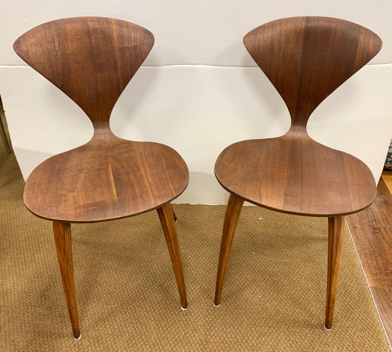 Sculptural pair of Norman Cherner Plycraft chairs made from steam form bent walnut, circa 1950's. Unique, original, iconic and coveted. Own the best.