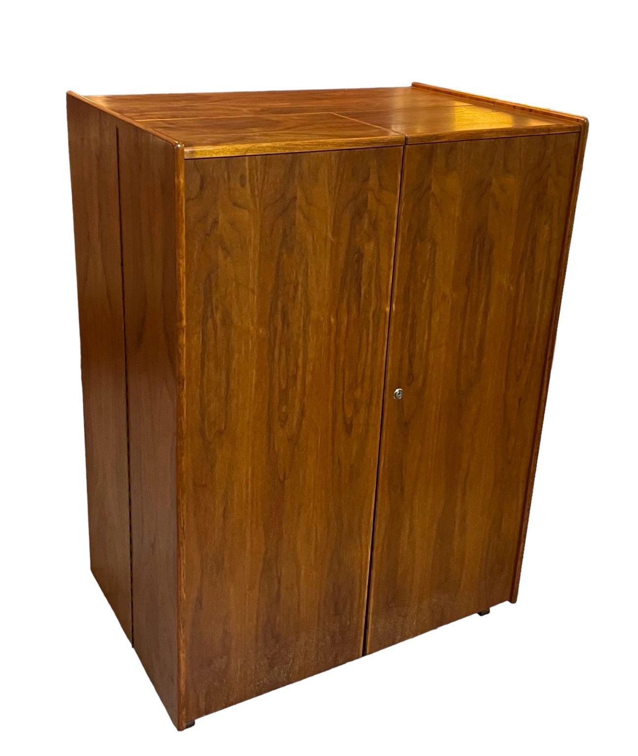 Classic Norwegian Mid-Century “Magic Box”. Tall handsome cabinet that opens to an intricate desk with a multitude of storage space and shelving. Beautiful craftsmanship with a rich walnut case and a light birch interior. Has the original swing out