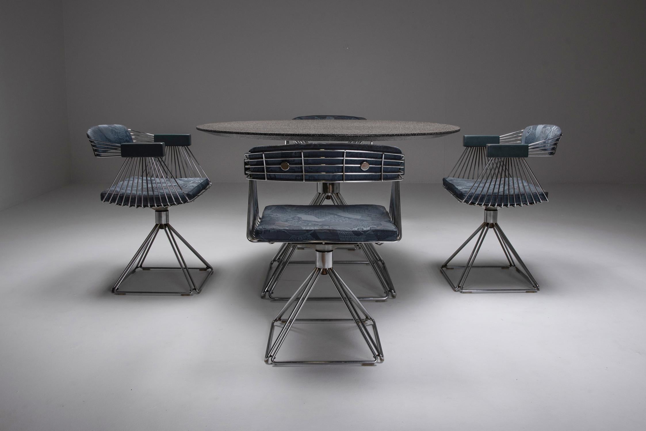 Extraordinary dining set created by Rudi Verelst for Novalux in 1970s Belgium. The set features swivel dining chairs crafted from gleaming chromed steel wire, elegantly complemented by a matching round dining table. The table boasts a stunning