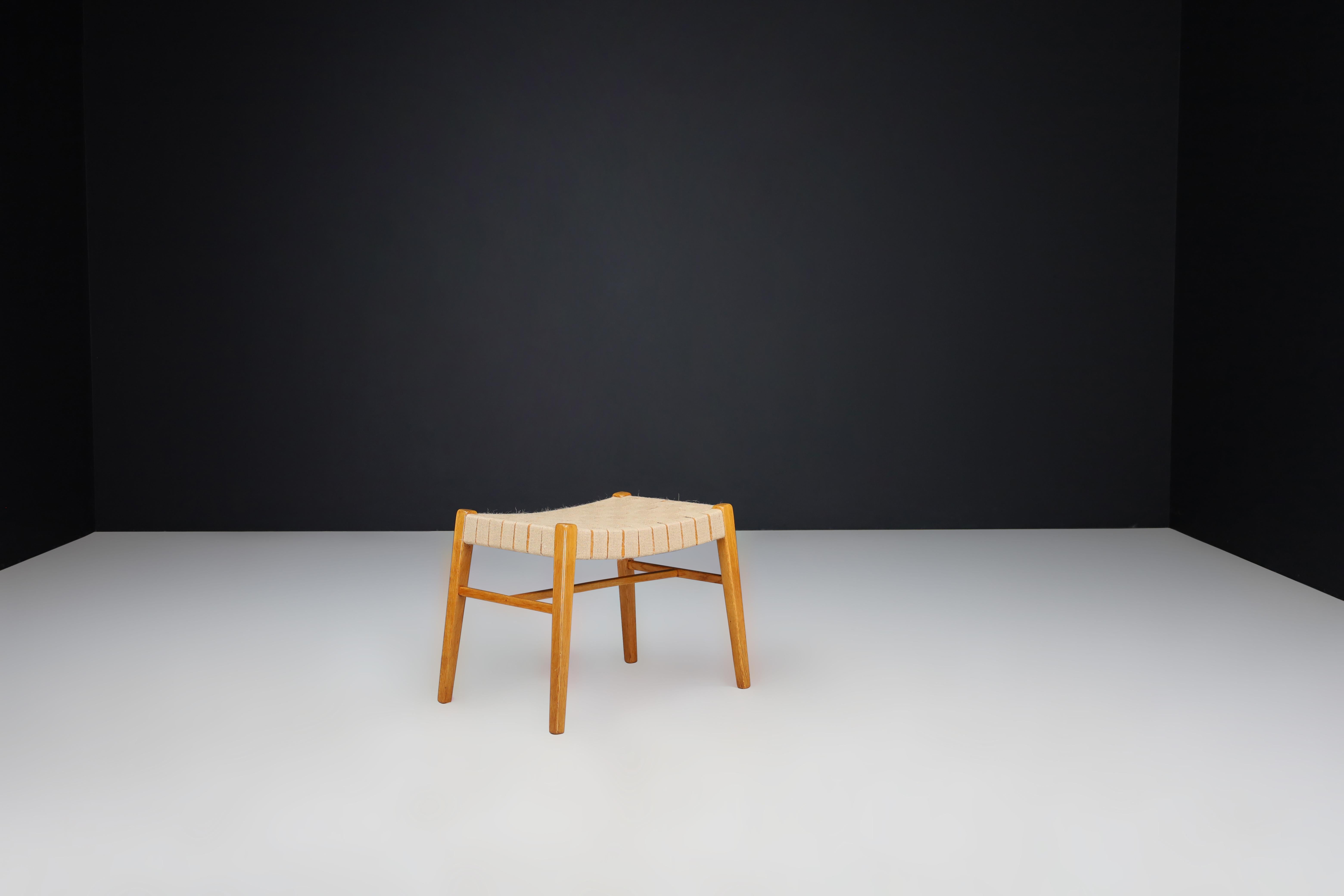 Mid-Century Modern Oak and Canvas Stool by Jan Vaněk, Prague, 1940s

A rare and beautifully crafted oak and canvas stool designed by Czech architect and designer Jan Vaněk in the 1940s. This minimalist piece exemplifies the refined elegance and