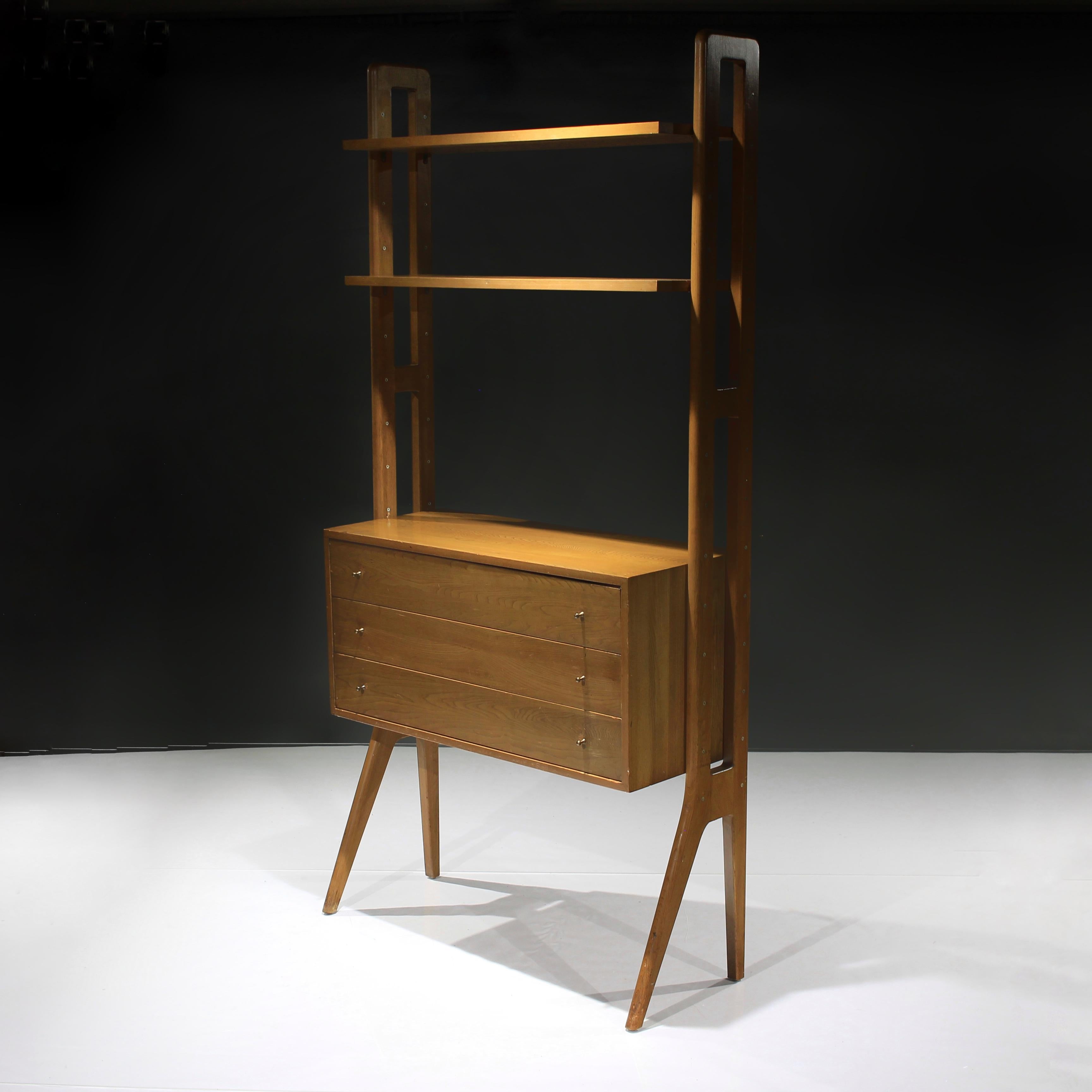 Presenting this beautiful bookcase with drawers in oak in the manner of Kurt Østervig of Denmark. Approximate age 1960s.

Incredible stately appearance with its splayed legs and versatile design element such as the adjustable drawer unit and