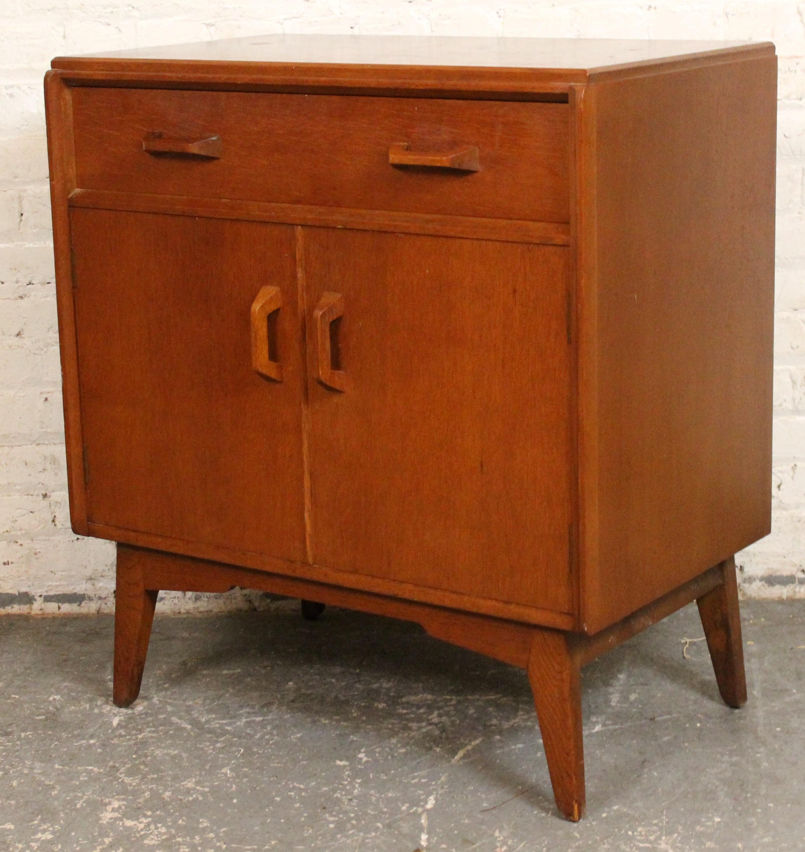 A refined mid-century oak cabinet by G-Plan, showcasing the brand’s signature blend of form and function. Featuring clean lines and ample storage, this piece reflects the timeless elegance and quality craftsmanship of British modernist design. Ideal