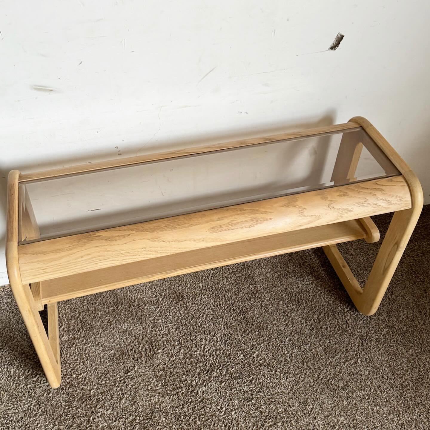 Embrace the timeless design of the Mid Century Modern Oak Console Table by Lou Hodges. This elegant piece combines a sturdy oak frame with a sophisticated smoked glass top. Its minimalist lines reflect Mid Century Modern aesthetics, making it