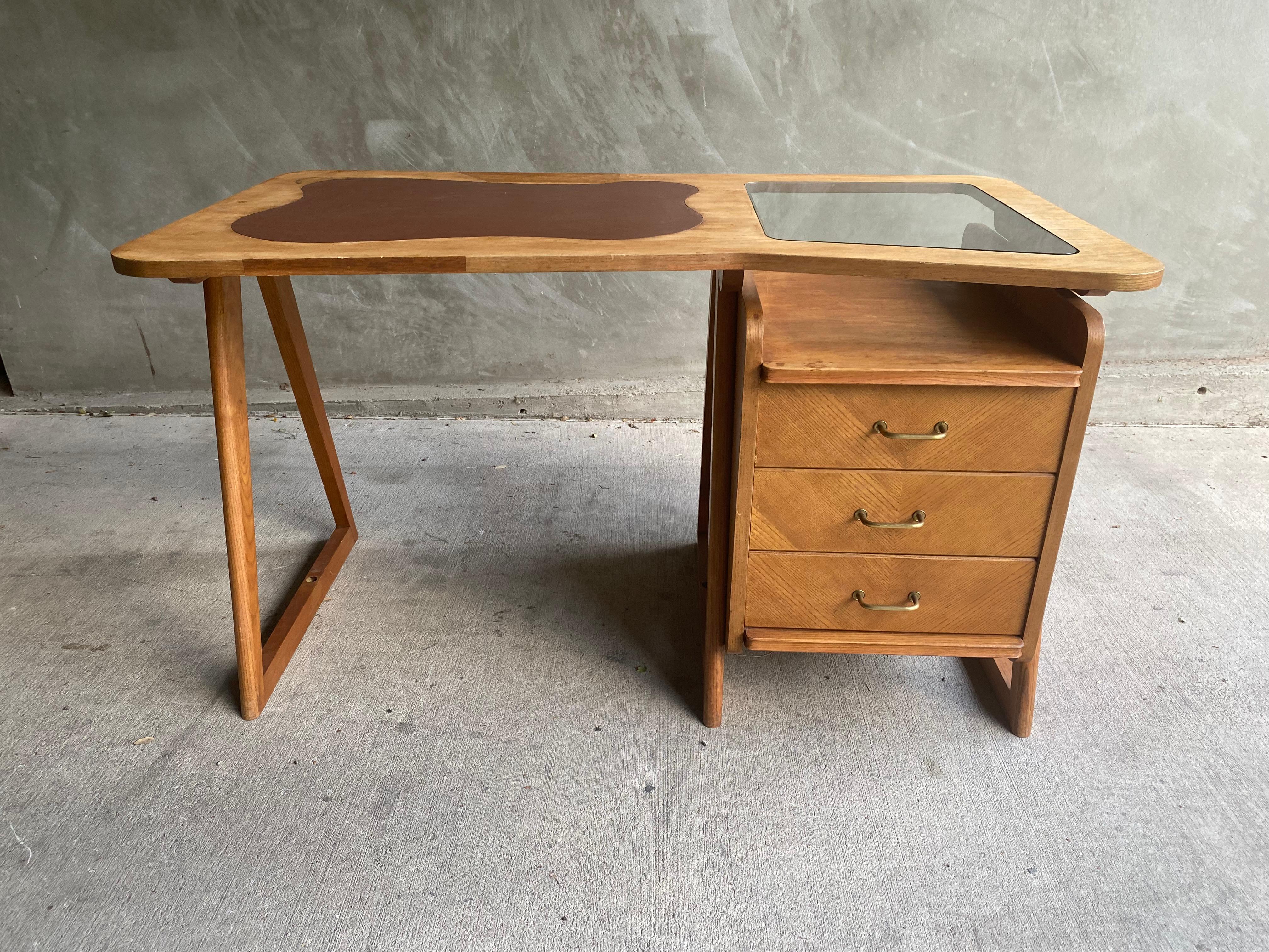 Mid-century oak desk with organic shaped top with inlaid glass and leather. Single stack of drawers and triangle legs. From same period, region and style as Guillerme et Chambron. France, 1950's
