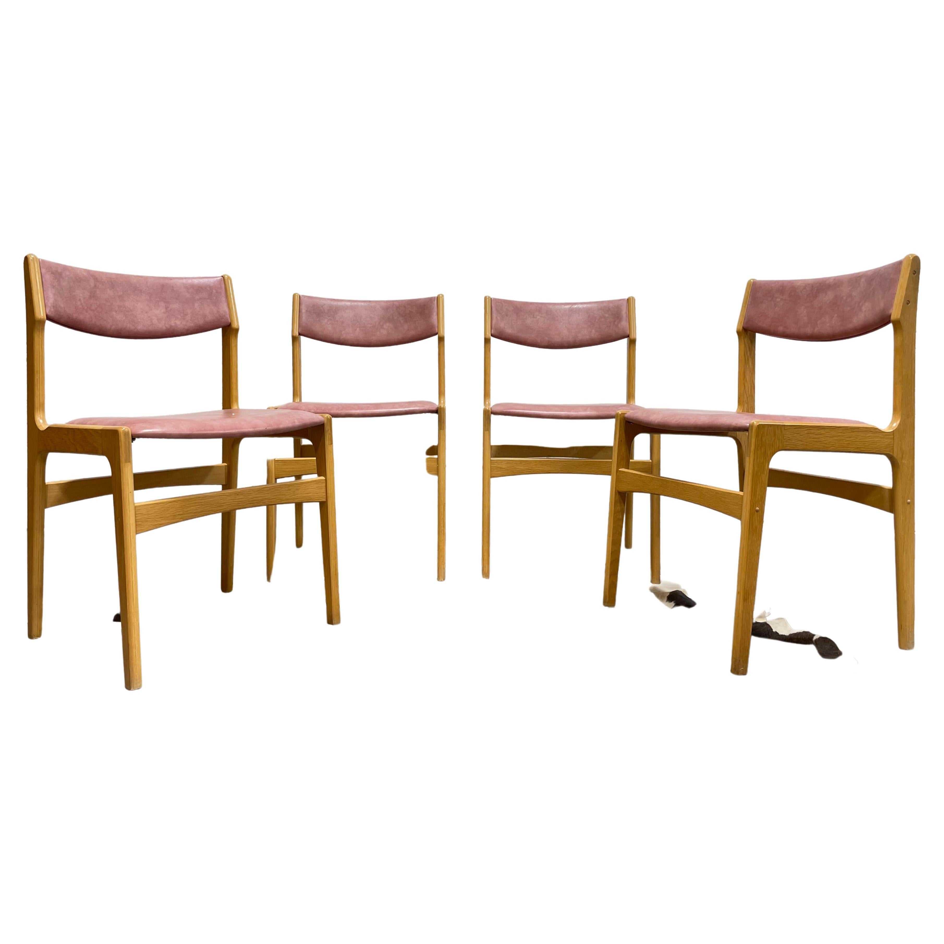 Set of four Oak Mid Century Modern Dining Chairs with Pink naugahyde upholstery. Beautifully sculpted, these super comfortable chairs feature an organic design and glorious oak frames that have been freshly cleaned and oiled and ready to be enjoyed