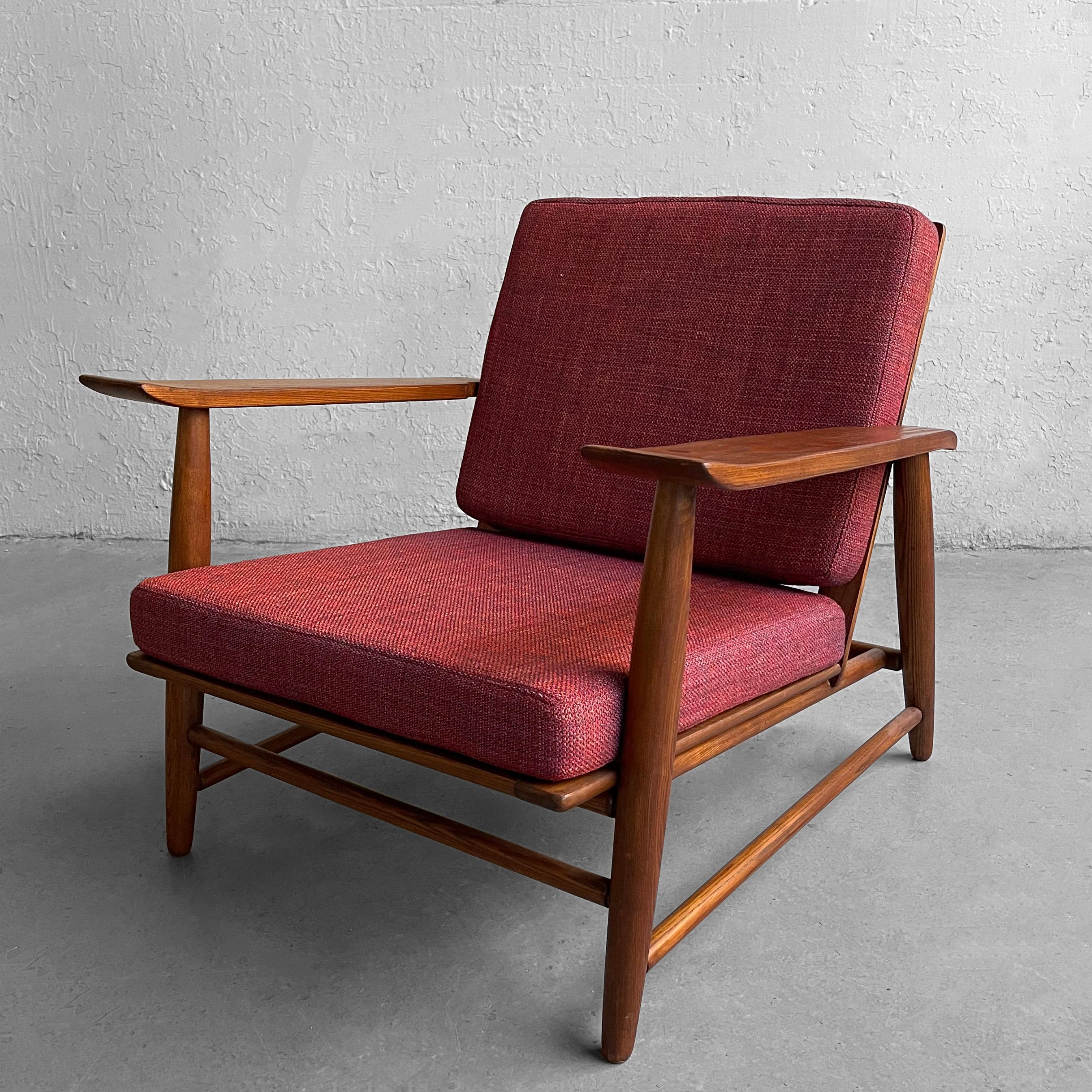 Handsome, Mid-Century Modern, lounge chair by Heywood Wakefield features a low-profile, oak frame with wide upturned arms. The cushions are newly upholstered in red tweed blend.