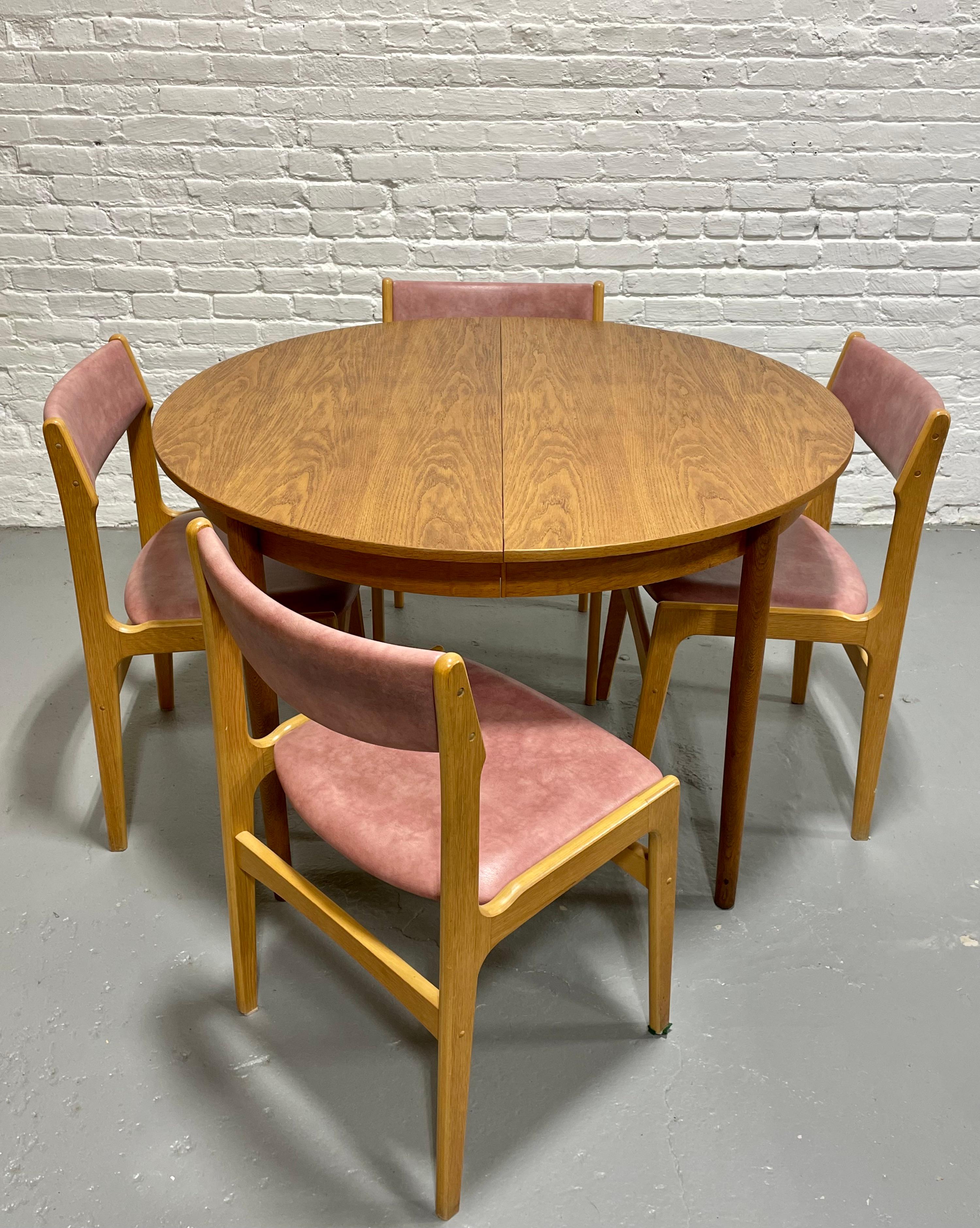 Mid Century Modern Oak Dining Table attributed to Borge Mogensen, Made in Denmark, c. 1960's. This solid oak table transforms from a round to a lovely oval table that comfortably seats 6 guests.  Perfect when space is limited - comfortably seat 4