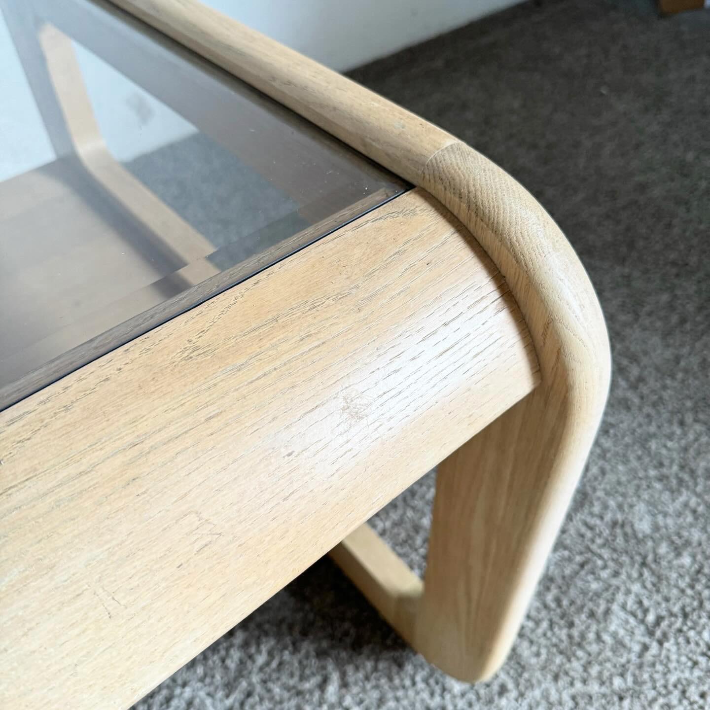 Experience the blend of vintage charm and modern design with the Mid Century Modern Oak Side Table by Lou Hodges. This table features a sturdy oak frame with a natural finish, embodying the clean lines of Mid Century Modern aesthetics. The smoked