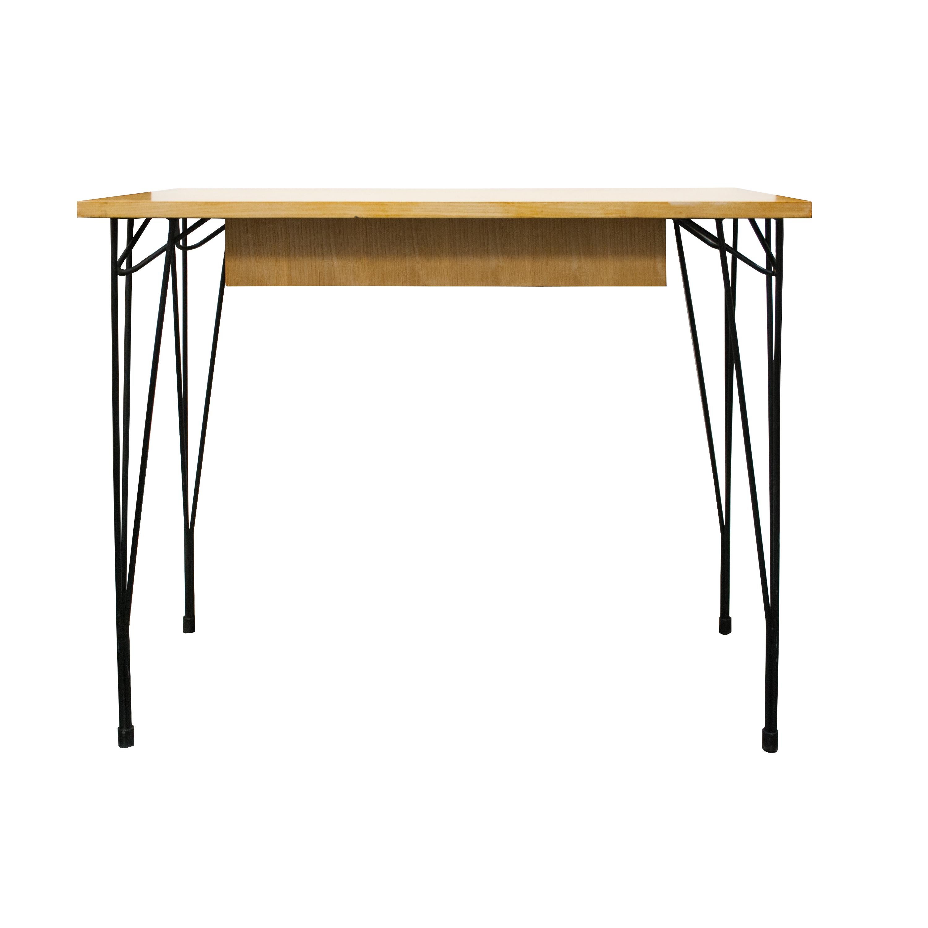 1950's original Mid-Century Modern desk edited by ISA Bergamo. 
The desk is composed of a table with a drawer and open space beneath made of oak wood. Legs made of curved and black lacquered iron rod.