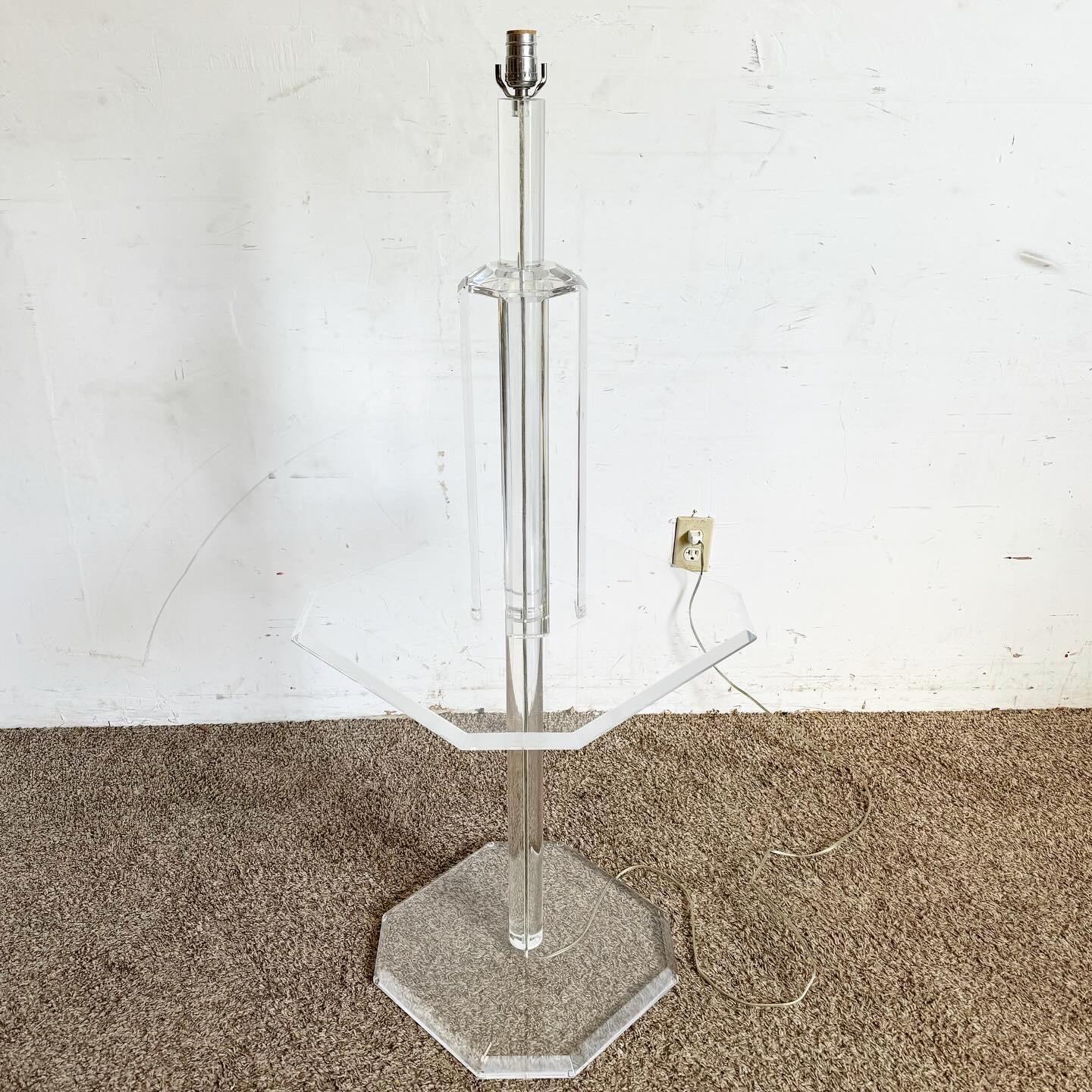 Transform your living space with this Mid Century Modern Octagonal Lucite Side Table/Floor Lamp. This piece marries utility with style, serving as both a lamp and a side table. The transparent Lucite structure and octagonal shape infuse your room