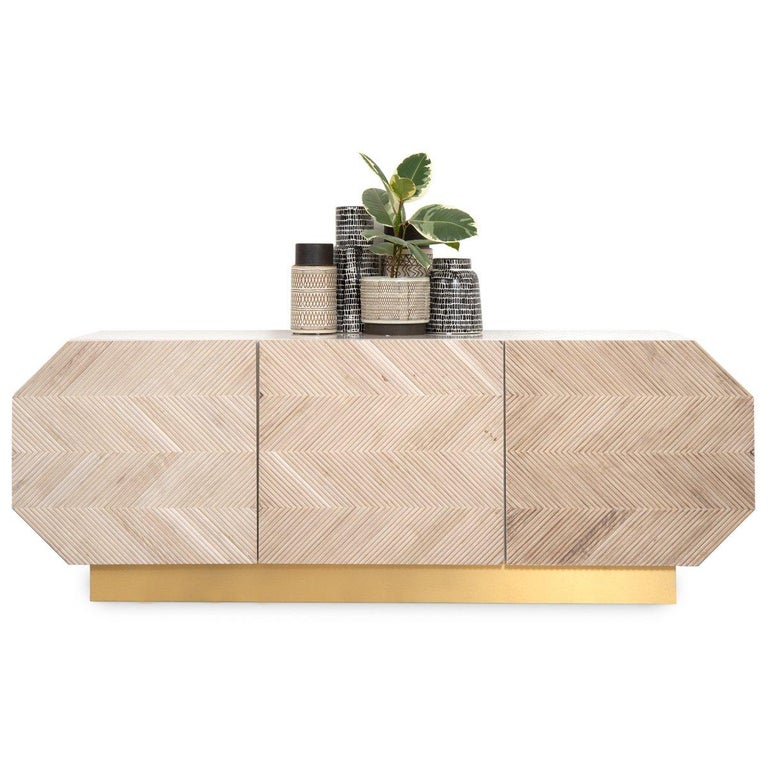 Featuring bleached North American walnut placed in a stunning herringbone design on the door fronts, an eye-catching elongated octagonal shape, and a beautiful matte Collingwood lacquer case, this credenza is the perfect mix of natural and man-made