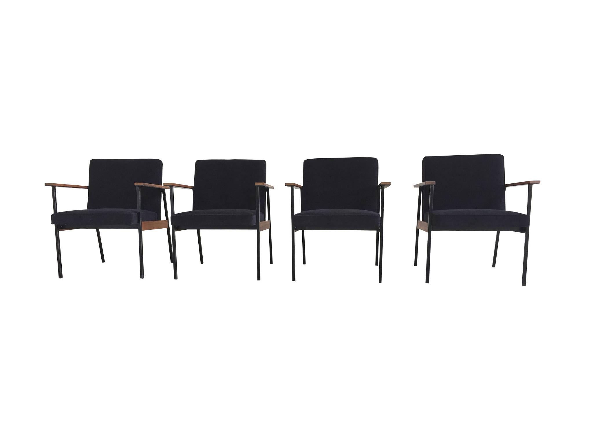 These four office chairs are attributed to the American designer, Paul McCobb. They were manufactured in the late 1950s and are in excellent condition. The frame consists of iron and walnut wood, while the seat and back are cushioned and