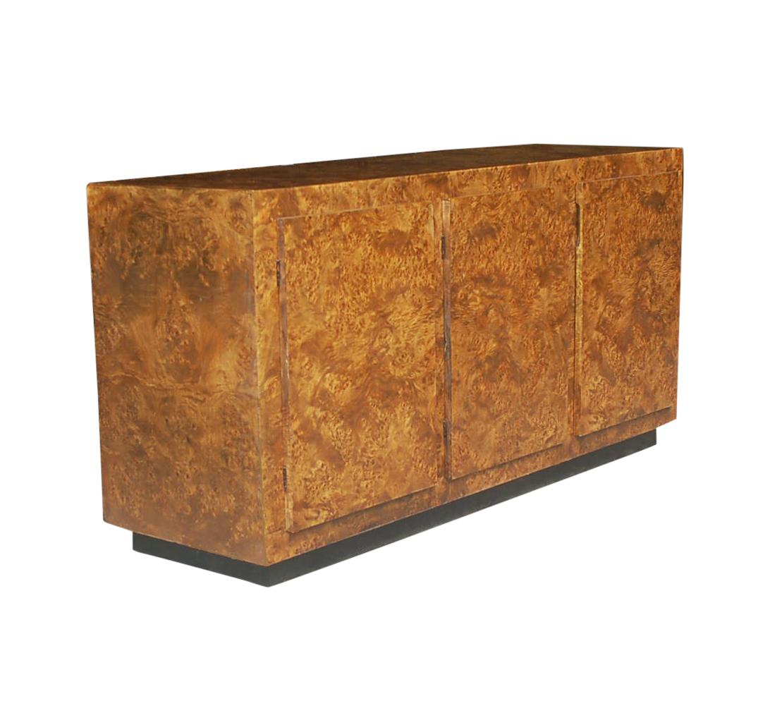 A nice smaller scale cabinet for a chic urban apartment. This credenza features a fully finished exterior in beautiful burl wood. Clean modern look with plenty of storage space.