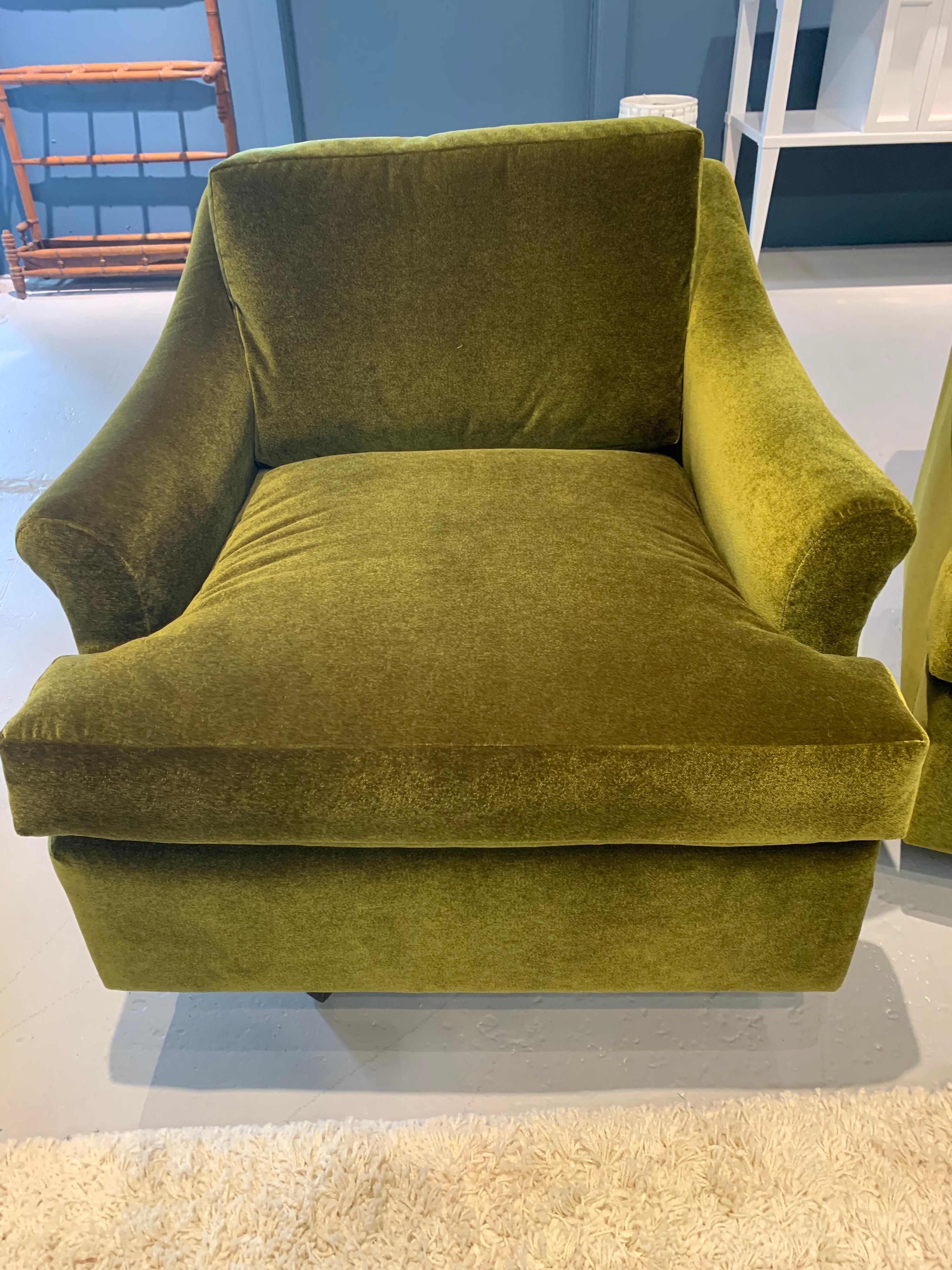 Newly upholstered in a luxurious green velvet fabric is this pair of matching mid century swivel chairs. All dimensions are attached. Chairs swivel 360 degrees. Own the best.