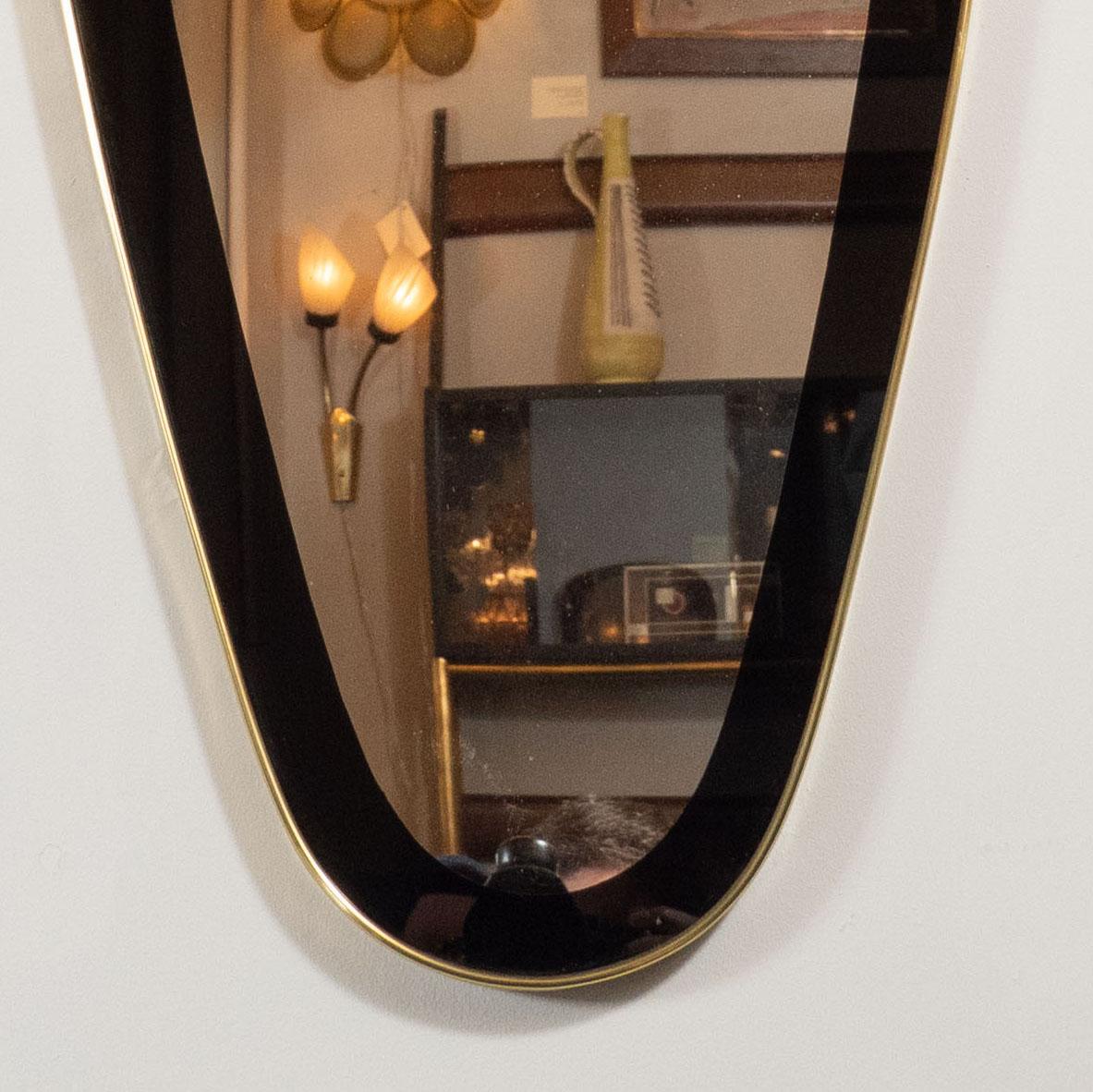 Mid-Century Modern Onyx Painted Reverse Églomisé Brass Wrapped Oval Mirror In Excellent Condition In New York, NY