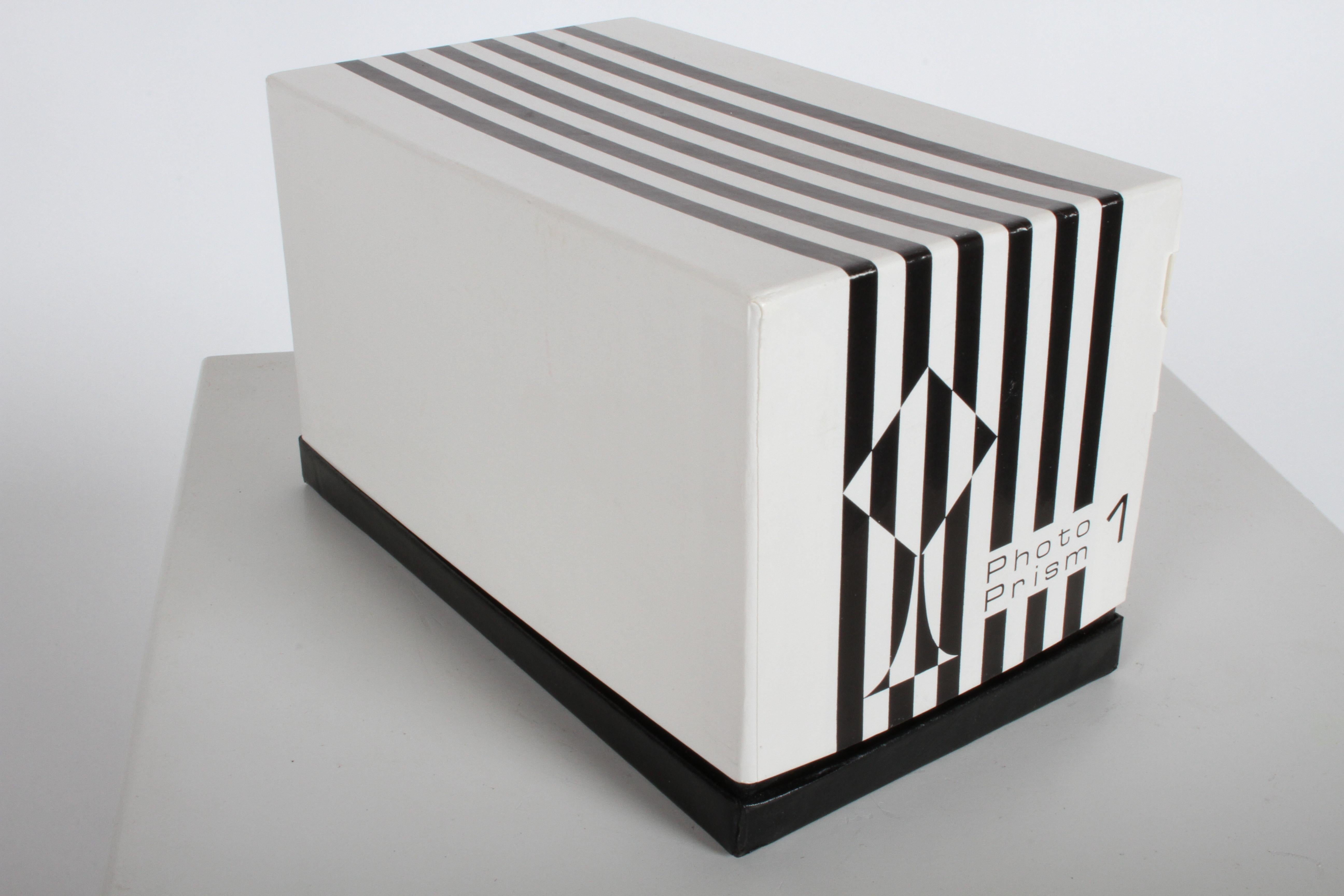 Vintage 1960s Mod OP art Lucite and chrome base Photo Prism sculpture designed by Bob Cornell creations in unused, new in the box condition. The photo frame brochure, says its a fine precision instrument - a unique sculpture form - a useful gift -