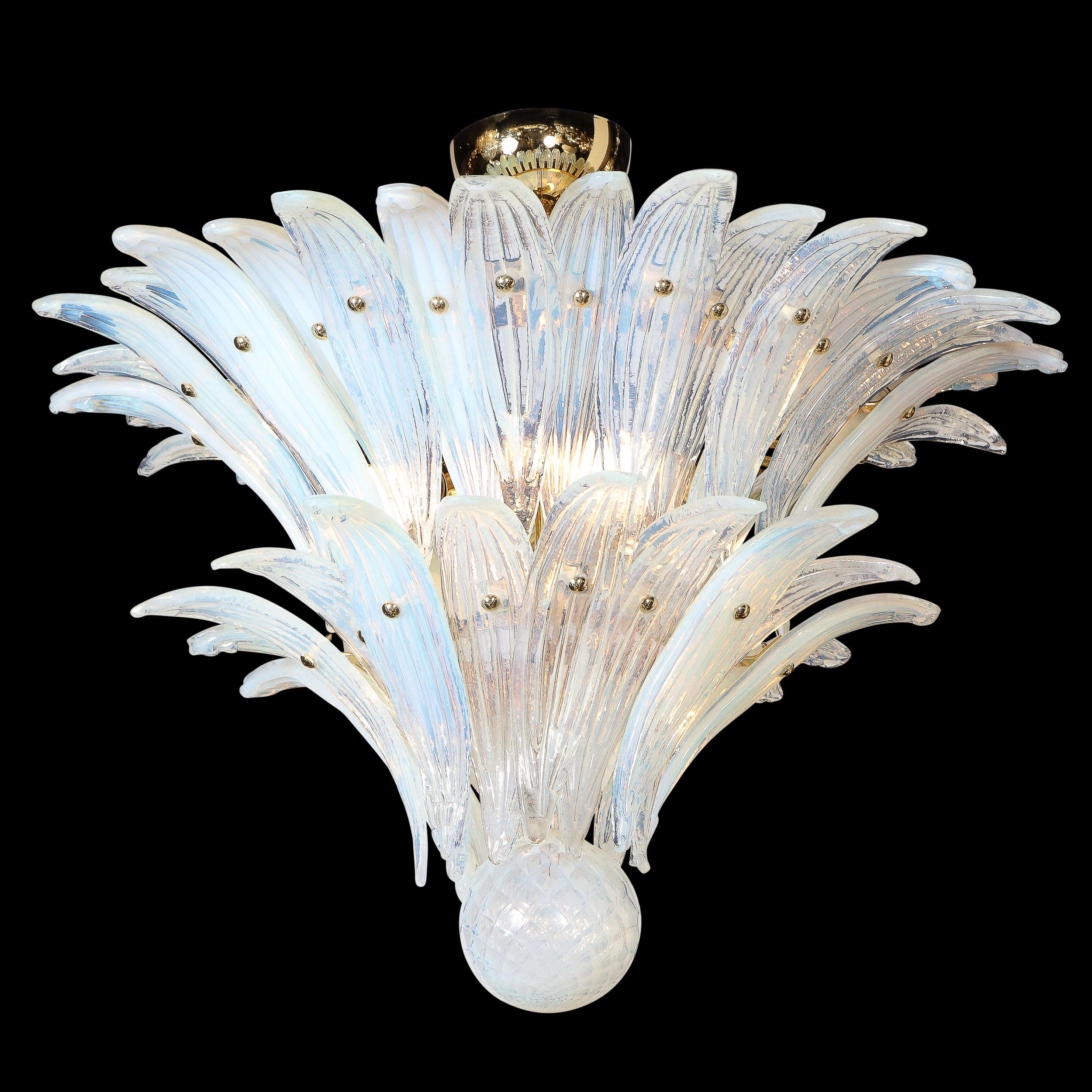 This graphic and glamorous Mid Century Modern Palma chandelier was handblown in Murano, Italy- the island off the coast of Venice renowned for centuries for its superlative glass production- circa 1970. It features to concentric rows of opalescent