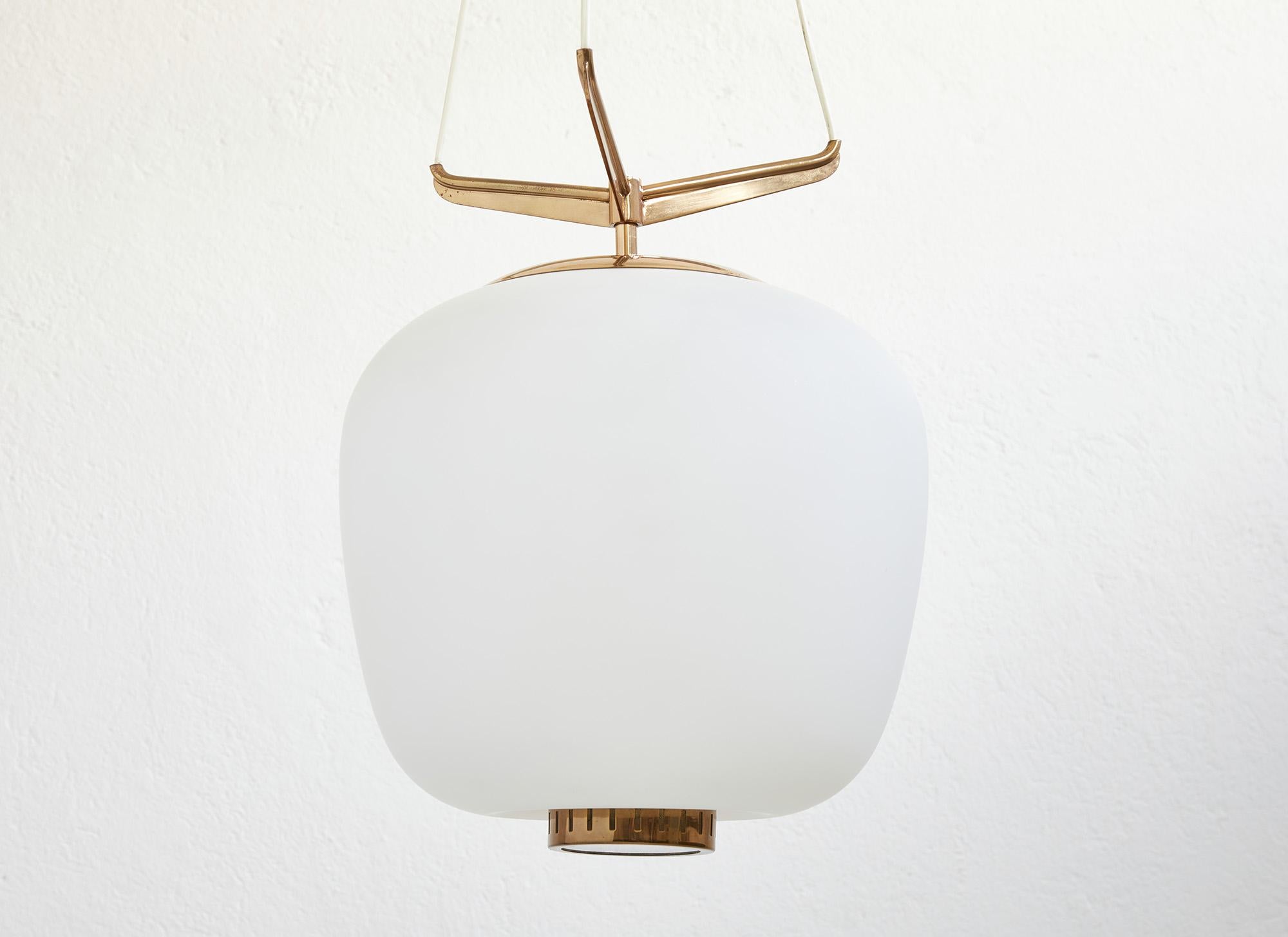 Mid-century modern Italian chandelier designed and produced by Stilnovo, Italy around 1950.

The gorgeous oval-shaped opaline glass shade produces a soft ethereal glow, delicately suspended by a sculptural frame of polished brass designed with